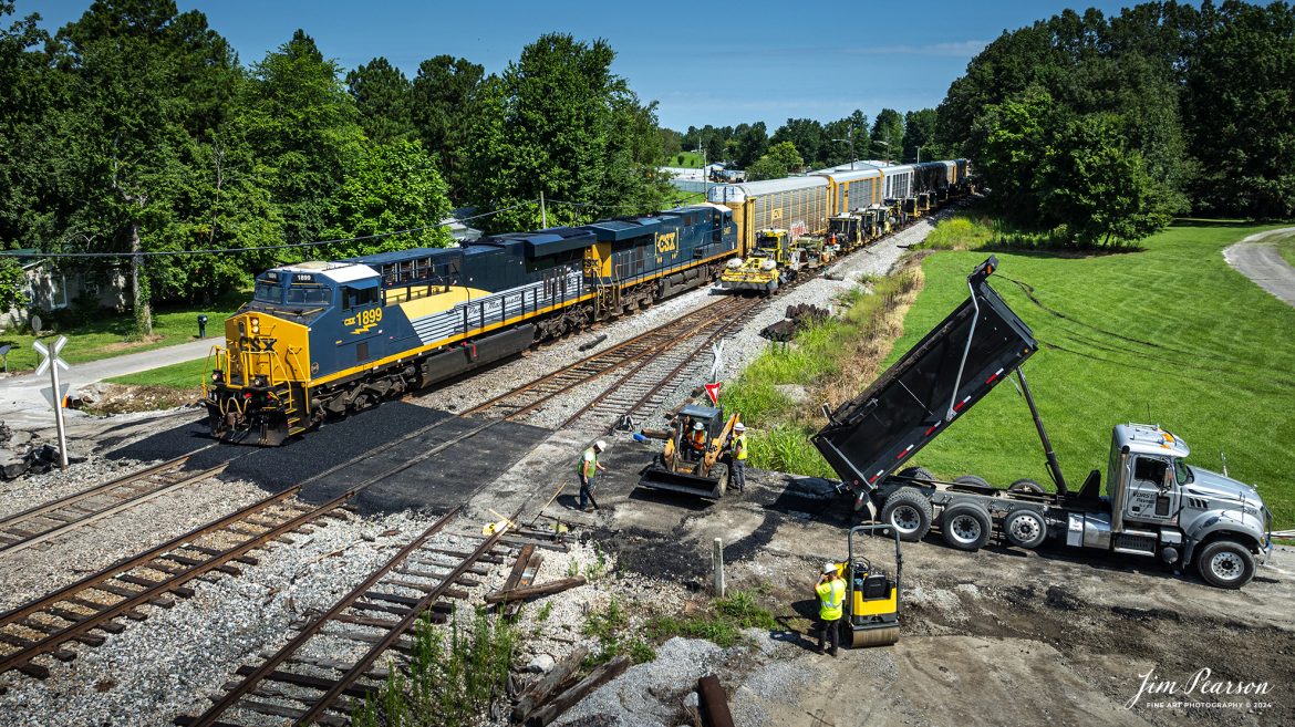 CSX I025 heads southbound with CSX Pere Marquette Heritage Unit, 1899, leading the way along the CSX Henderson Subdivision, as they roll slowly through a work area where a crew is working on one of the crossings at Hanson, Kentucky, on July 18th, 2024. 

According to a CSX Press Release: May 1, 2024 - CSX has introduced the latest addition in its heritage locomotive series, paying homage to the rich history of the Pere Marquette Railroad. This new unit showcases the Pere Marquette's legacy, dating back to its inception on November 1, 1899.
 
The Pere Marquette Railroad, operating in the Great Lakes region of the United States and parts of southern Ontario, Canada, derived its name from Jacques Marquette, a notable French Jesuit missionary credited with founding Michigan's first European settlement in Sault Ste Marie. After years of operation, the company merged with the Chesapeake and Ohio Railway (C&O) on June 6, 1947, eventually becoming part of the renowned CSX network.
 
The design of the Pere Marquette heritage locomotive was meticulously crafted by employees at the CSX Waycross Locomotive Shop. According to CSX Carman Painter Eric Lee, “We had to measure each stripe precisely and position the words just right to ensure it captured the look of the original design. It took us about four days just to lay out the stripes before we could begin painting.”
 
A fascinating tidbit related to the history of Pere Marquette is its cameo in the 2004 film "The Polar Express." The steam locomotive Pere Marquette 1225 served as the inspiration for the train depicted in the movie, with audio recordings of the actual locomotive in operation featured in the film. Interestingly, the locomotive had been donated to Michigan State University and was exhibited near the university's football stadium. The author of "The Polar Express" book drew inspiration from seeing this locomotive on display during childhood, solidifying its place in popular culture.
 
CSX's dedication to honoring the history and significance of the Pere Marquette Railroad through this new locomotive underscores the company's commitment to preserving and celebrating the heritage of American railroads. Keep an eye out as this remarkable piece of history moves across the CSX network, bridging the past with the present.

Tech Info: DJI Mavic 3 Classic Drone, RAW, 22mm, f/2.8, 1/1600, ISO 100.

#railroad #railroads #train, #trains #railway #railway #steamtrains #railtransport #railroadengines #picturesoftrains #picturesofrailways #besttrainphotograph #bestphoto #photographyoftrains #steamtrainphotography #CSXPereMarquetteheritageunit #bestsoldpicture #JimPearsonPhotography #csxheritagelocomotive