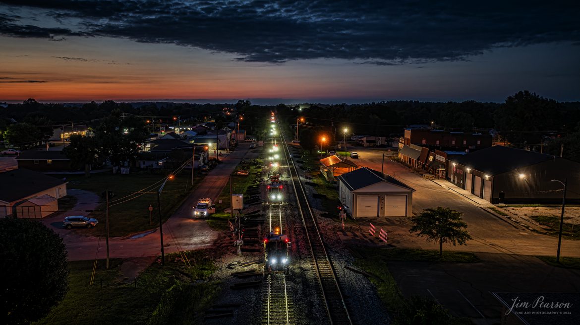 The sun has set, and dusk has arrived over the CSX Henderson Subdivision at Crofton, Kentucky on July 19th, 2024, and a parade of track working equipment, and men have began working their way south through town during the first week of a three-week work curfew on the line. CSX has been running most of their trains during daylight hours to allow track workers to replace ties, crossings and other types of maintenance work on the subdivision.

Tech Info: DJI Mavic 3 Classic Drone, RAW, 22mm, f/2.8, 1/15, ISO 140, -2.0 exposure compensation for the highlights.

#railroad #railroads #train #trains #bestphoto #railroadengines #picturesoftrains #picturesofrailway #bestphotograph #photographyoftrains #trainphotography #JimPearsonPhotography #trendingphoto #csxt #trainsfromadrone #trainsatnight