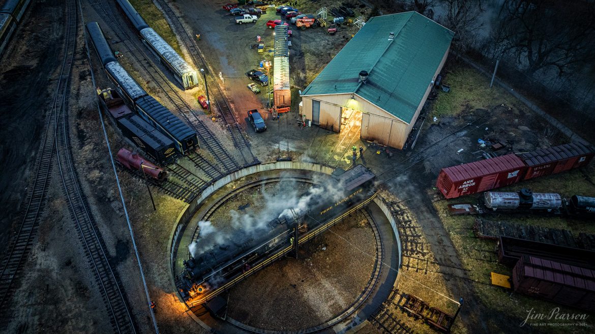 An early morning view of Steam Railroading Institute’s Pere Marquette 1225 as it sits on the turntable at Owosso, Michigan. It was being serviced by crews before it backed up to the ash pit in preparation for another day of pulling the North Pole Express between Owosso and Ashley, Michigan, along the Great Lakes Railroad on December 17th, 2023. 

According to their website, Pere Marquette 1225, the largest and most impressive piece in the Steam Railroading Institute’s collection, is one of the largest operating steam locomotives in Michigan. The 1225 was built in October of 1941 by the Lima Locomotive Works in Lima, Ohio for the Pere Marquette Railway. It’s part of the National Register of Historic Structures and is renowned for its role in the 2004 Warner Brothers Christmas Classic, THE POLAR EXPRESS™. 1225’s blueprints were used as the prototype for the locomotive image as well as its sounds to bring the train in the animated film to life!

Tech Info: DJI Mavic 3 Classic Drone, RAW, 22mm, f/2.8, 1/10, ISO 680.

#railroad #railroads #train, #trains #railway #railway #steamtrains #railtransport #railroadengines #picturesoftrains #picturesofrailways #besttrainphotograph #bestphoto #photographyoftrains #steamtrainphotography # PereMarquette1225 #bestsoldpicture #JimPearsonPhotography #northpoleexpress