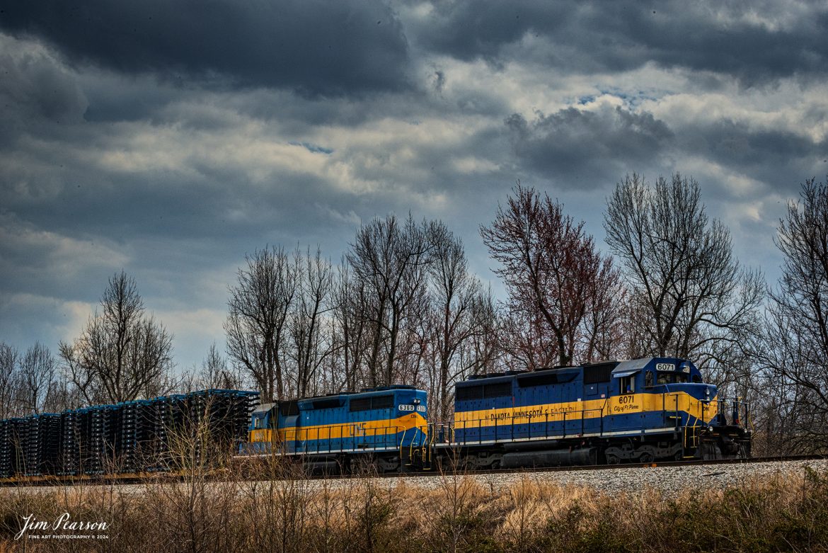 April 2nd, 2014 - Blast from The Past – Looking though my archives I stumbled across this image of Dakota, Minnesota & Eastern 6071 (City of Ft. Pierre) and 6030 leading a mixed freight hauling truck frames behind the power just south of Mortons Gap, Kentucky headed north on the CSX Henderson Subdivision. These frames are hauled by M512 today, so I’m guessing perhaps back then it would have been Q512.

According to eh Global Energy Monitor Wiki website: The Dakota, Minnesota and Eastern Railroad reporting mark is a Class II railroad subsidiary of the Canadian Pacific Railway operating across South Dakota and southern Minnesota in the northern plains of the United States. Portions of the railroad also extend into Wyoming, Nebraska and Iowa.

DM&E began operations on September 5, 1986, over tracks that were spun off from the Chicago and Northwestern Transportation Company in South Dakota and Minnesota. Much of the negotiations were handled by the office of Senator Larry Pressler and his legal counsel Kevin V. Schieffer. After a successful decade of growth for DM&E, Schieffer succeeded J. C. McIntyre as president of the railroad on November 7, 1996. In 1997 DM&E announced plans to build into Wyoming's Powder River Basin to become the third railroad (after BNSF Railway and Union Pacific Railroad) to tap into the region's rich coal deposits. The Surface Transportation Board (STB) released the final Environmental Impact Statement (EIS) on November 19, 2001; with the final EIS in place and approval from the STB, the railroad has federal authority to construct the project.

DM&E purchased the assets of I&M Rail Link railroad in 2002, renaming it Iowa, Chicago and Eastern Railroad and combining its management and dispatching duties with those of DM&E under the holding company Cedar American Rail Holdings. Schieffer served as president and CEO of Cedar as well as serving as president of DM&E. The combined system directly connects Chicago, Illinois through Iowa to Kansas City, Missouri, Minneapolis-St. Paul and continues as far west as Rapid City, South Dakota. Smaller branches extend into portions of Wisconsin, Wyoming and Nebraska.

In September 2007 it was announced that Canadian Pacific Railway (CP) would acquire the DM&E upon approval by the Surface Transportation Board of the US Department of Transportation. The STB announced its approval of the purchase plan on September 30, 2008, with the official last day of operations for DM&E scheduled for October 30, 2008. The merger is complete as of October 31, 2008

Tech Info: Nikon D100, Nikon 70-300mm @70mm, f/32, 1/400, ISO 800.

#trainphotography #railroadphotography #trains #railways #trainphotographer #railroadphotographer #jimpearsonphotography # DakotaMinnesotaandEastern