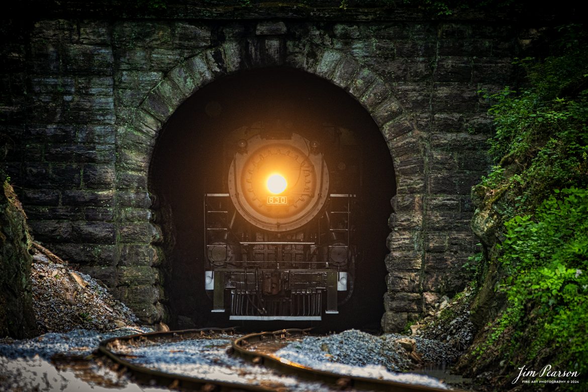 Tennessee Valley Railroad Museum’s steam locomotive Southern Railway 630 exits Missionary Ridge Tunnel as it approaches East Chattanooga, Tennessee with a trainload of passengers, on April 27th, 2024. 

According to Wikipedia: Southern Railway 630 is a 2-8-0 "Consolidation" type steam locomotive built in February 1904 by the American Locomotive Company (ALCO) of Richmond, Virginia for the Southern Railway as a member of the Ks-1 class. It is currently owned and operated by the Tennessee Valley Railroad Museum in Chattanooga, Tennessee where it resides today for use on excursion trains.

According to the Tennessee River Valley Tourism site: Tennessee Valley Railroad Museum's passenger trains run on an historic route which includes Missionary Ridge Tunnel, completed in 1858 and on the National Register of Historic Places. The tunnel is the primary reason TVRM runs on the three-mile section of the former Southern Railway. As railroad equipment grew too large to pass through, the single-track tunnel became a traffic jam for an other wise double-track railroad. Southern Railway abandoned the three-mile portion of the line and built a new section around the end of Missionary Ridge, avoiding the tunnel altogether. TVRM restored rails through the tunnel in 1971 and continues to use the pre-Civil War Tunnel daily.

Tech Info: Nikon D800, Sigma 150-600 @ 370mm, f/6, 1/250, ISO 1100.

#trainphotography #railroadphotography #trains #railways #trainphotographer #railroadphotographer #jimpearsonphotography #PassengerTrain #TennesseeValleyRailroadMuseum #TennesseeTrains #steamtrain #tvrm