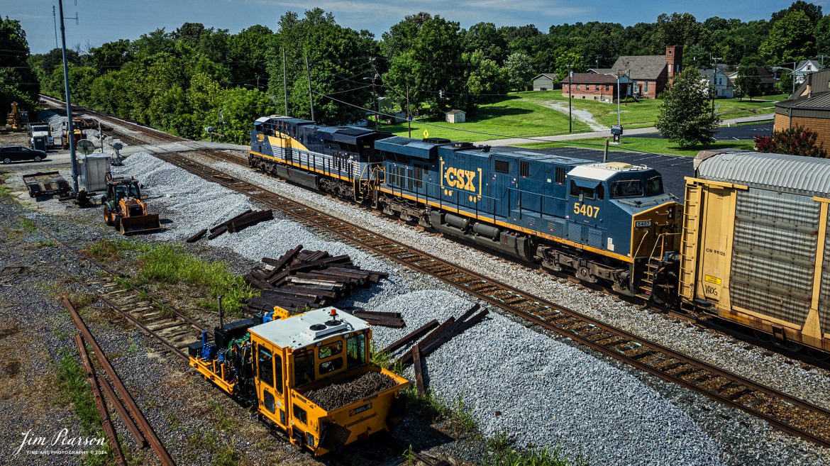 CSX I025 heads southbound with CSX Pere Marquette Heritage Unit 1899, leading the way along the CSX Henderson Subdivision, as they pass through Hanson, Kentucky, on July 18th, 2024. 

According to a CSX Press Release: May 1, 2024 - CSX has introduced the latest addition in its heritage locomotive series, paying homage to the rich history of the Pere Marquette Railroad. This new unit showcases the Pere Marquette's legacy, dating back to its inception on November 1, 1899.
 
The Pere Marquette Railroad, operating in the Great Lakes region of the United States and parts of southern Ontario, Canada, derived its name from Jacques Marquette, a notable French Jesuit missionary credited with founding Michigan's first European settlement in Sault Ste Marie. After years of operation, the company merged with the Chesapeake and Ohio Railway (C&O) on June 6, 1947, eventually becoming part of the renowned CSX network.
 
The design of the Pere Marquette heritage locomotive was meticulously crafted by employees at the CSX Waycross Locomotive Shop. According to CSX Carman Painter Eric Lee, “We had to measure each stripe precisely and position the words just right to ensure it captured the look of the original design. It took us about four days just to lay out the stripes before we could begin painting.”
 
A fascinating tidbit related to the history of Pere Marquette is its cameo in the 2004 film "The Polar Express." The steam locomotive Pere Marquette 1225 served as the inspiration for the train depicted in the movie, with audio recordings of the actual locomotive in operation featured in the film. Interestingly, the locomotive had been donated to Michigan State University and was exhibited near the university's football stadium. The author of "The Polar Express" book drew inspiration from seeing this locomotive on display during childhood, solidifying its place in popular culture.
 
CSX's dedication to honoring the history and significance of the Pere Marquette Railroad through this new locomotive underscores the company's commitment to preserving and celebrating the heritage of American railroads. Keep an eye out as this remarkable piece of history moves across the CSX network, bridging the past with the present.

Tech Info: DJI Mavic 3 Classic Drone, RAW, 22mm, f/2.8, 1/2000, ISO 100.

#railroad #railroads #train, #trains #railway #railway #steamtrains #railtransport #railroadengines #picturesoftrains #picturesofrailways #besttrainphotograph #bestphoto #photographyoftrains #steamtrainphotography #CSXPereMarquetteheritageunit #bestsoldpicture #JimPearsonPhotography #csxheritagelocomotive