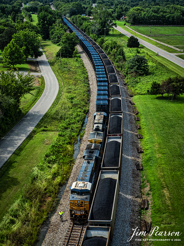 The conductor on G376 does a roll-by inspection on a southbound loaded coal train C305 as they meet at the north end of the siding in Kelly, Kentucky on July 31st, 2024, on the CSX Henderson Subdivision.

In addition to their empty grain loads they stopped and picked up a long string of truck frames at Hopkinsville for Toyota up in Indiana. Normally they are picked up by M512 but ended up on this empty grain train today.

Tech Info: DJI Mavic 3 Classic Drone, RAW, 22mm, f/2.8, 1/1600, ISO 140.

#railroad #railroads #train #trains #bestphoto #railroadengines #picturesoftrains #picturesofrailway #bestphotograph #photographyoftrains #trainphotography #JimPearsonPhotography #trendingphoto #csxt #trainsfromadrone