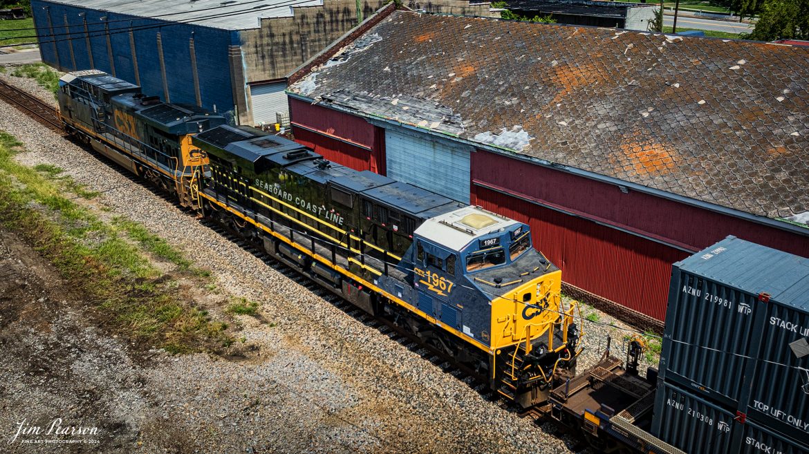 CSX I026 with CSX Seaboard Coast Line Railroad Heritage Unit (SCL) 1967, trailing second. heads north at Hopkinsville, Kentucky on the CSX Henderson Subdivision, on June 24th, 2024. 

According to a CSX Press Release: June 6, 2024 - CSX has released a new heritage locomotive, the P&LE 1875, paying tribute to the storied Pittsburgh & Lake Erie Railroad (P&LE). The 15th in CSX’s heritage locomotive series, this new addition to the company’s fleet not only celebrates the rich history of P&LE but also marks a significant milestone in CSX's ongoing commitment to honoring the legacies of America's historic railroads.

The Pittsburgh & Lake Erie Railroad was established in 1875 with a primary mission of transporting essential industrial materials such as coal, coke, iron ore, limestone, and steel among the bustling industrial hubs of the region. 

“It’s mainline connected Pittsburgh, Pennsylvania with Youngstown, Ohio and Connellsville, Pennsylvania. It did not actually reach Lake Erie until 1976,” explained Tim Music, a carman painter at the CSX Waycross Locomotive Shop where the unit was produced.

Despite its relatively modest route mileage, the P&LE Railroad earned the nickname "Little Giant" due to the enormous volume of heavy tonnage it moved. This impressive capability drew significant attention and by 1887, the P&LE became a subsidiary of the dominant New York Central Railroad. Under this new ownership, the P&LE enjoyed substantial improvements to its tracks and added capacity for passenger services, further enhancing its regional significance.

Over time, P&LE expanded by leasing branches from smaller railroads. These extensions included lines southeast along the Monongahela River through Homestead and McKeesport, and along the Youghiogheny River to Connellsville, where it connected with the Western Maryland Railway.

Tech Info: DJI Mavic 3 Classic Drone, RAW, 22mm, f/2.8, 1/3200, ISO 170.

#railroad #railroads #train, #trains #railway #railway #steamtrains #railtransport #railroadengines #picturesoftrains #picturesofrailways #besttrainphotograph #bestphoto #photographyoftrains #steamtrainphotography #CSXPLEheritageunit #bestsoldpicture #JimPearsonPhotography #csxheritagelocomotive