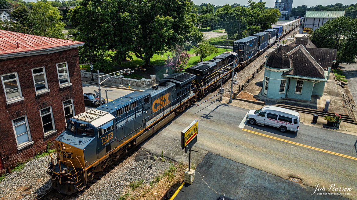 CSXT 7273 leads CSX I026 with the Seaboard Coast Line Railroad Heritage Unit (SCL) 1967 as the trailing unit, as they pass the old L&N Depot in downtown Hopkinsville, Ky, on their way north on the CSX Henderson Subdivision, on August 6th, 2024. The brick building to the left is the old L&N Freight Station.

According to a CSX Press Release: May 23, 2024 - CSX Transportation has launched its newest heritage locomotive, paying tribute to the Seaboard Coast Line Railroad (SCL). This latest addition is part of CSX's ongoing initiative to honor its historical roots while paving the way for the future of railroading in America.

The Seaboard Coast Line Railroad (SCL) was a prominent rail line that operated in the southeastern United States from 1967 until 1983. SCL emerged from the merger of the Seaboard Air Line Railroad and the Atlantic Coast Line Railroad. In 1986, SCL became part of CSX through a series of mergers and acquisitions that formed one of the largest Class I railroads in North America.

“When SCL was an active railroad, it was the eighth largest railroad with almost 10,000 miles across the southern United States,” explained CSX Carman Painter Jason Merritt, one of the team members who worked on the project. “In fact, the ‘S’ in CSX actually stands for Seaboard.”

CSX has been dedicated to preserving the legacy of the railroads that form its foundation by creating heritage locomotives. These locomotives are meticulously designed and crafted at the company's locomotive shop in Waycross, Georgia. Each piece represents a significant chapter in the rich history of American railroading.

CSX Carman Painter Tim Music said, "This project was especially meaningful to me because both my late brother and sister retired from CSX and experienced the Seaboard Coastline years. Growing up just 100 feet from the railroad tracks, I vividly recall the black and yellow SCL paint scheme passing by every day."

The new SCL heritage locomotive joins a growing fleet of locomotives that celebrate the diverse and storied past of CSX. The unit is the fourteenth in the series produced by the railroad. By honoring these historic lines, CSX not only pays homage to its origins but also inspires a deep appreciation for the role railroads have played in shaping the nation's infrastructure and economy.

Tech Info: DJI Mavic 3 Classic Drone, RAW, 22mm, f/2.8, 1/2000, ISO 100.

#railroad #railroads #train, #trains #railway #railway #steamtrains #railtransport #railroadengines #picturesoftrains #picturesofrailways #besttrainphotograph #bestphoto #photographyoftrains #steamtrainphotography #bestsoldpicture #JimPearsonPhotography #csxheritagelocomotive