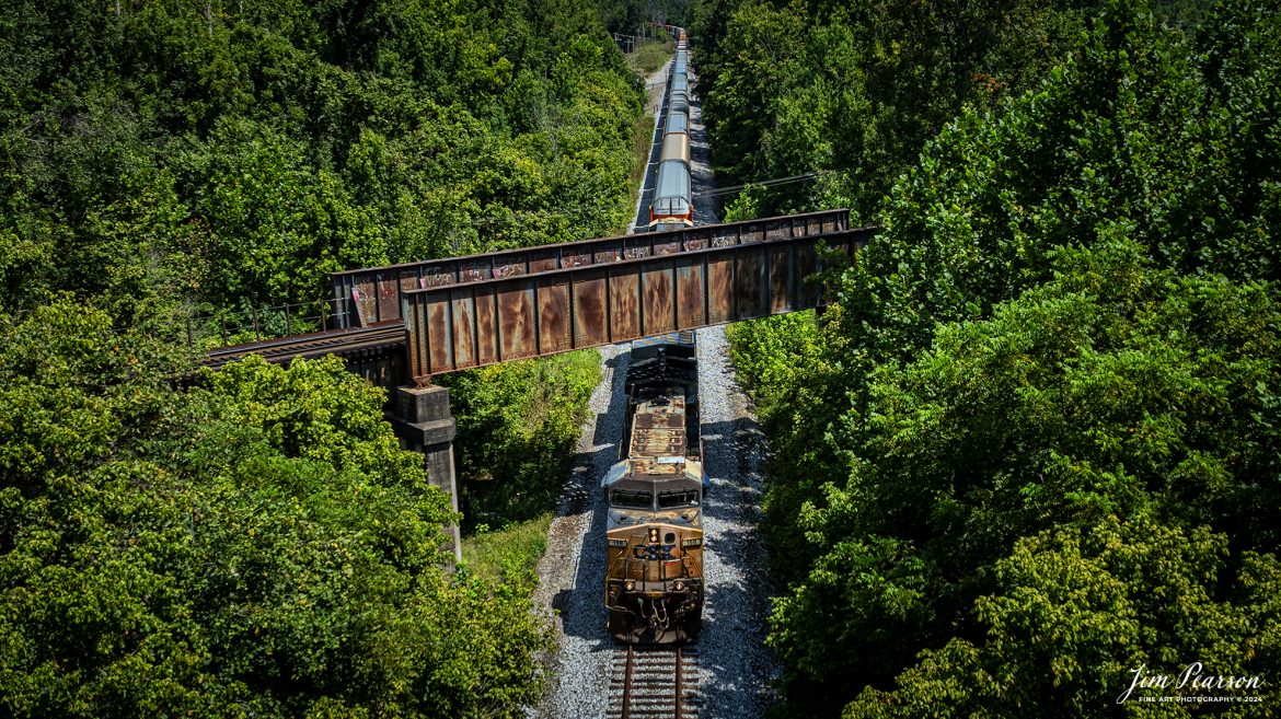 CSX hot intermodal I025 passes under the Paducah and Louisville Railway at the location known as Monarch at Madisonville, Kentucky on August 14th, 2024, as they head south on the CSX Henderson Subdivision.

Tech Info: DJI Mavic 3 Classic Drone, RAW, 24mm, f/2.8, 1/1600, ISO 110.

#railroad #railroads #train #trains #bestphoto #railroadengines #picturesoftrains #picturesofrailway #bestphotograph #photographyoftrains #trainphotography #JimPearsonPhotography #trendingphoto