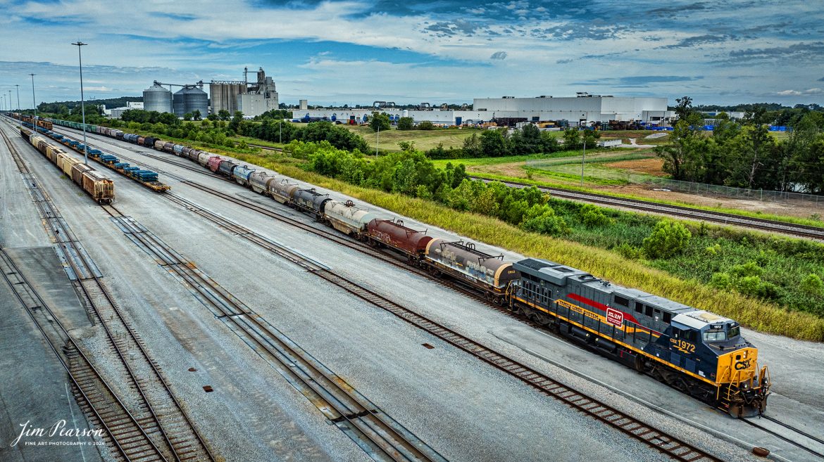 CSX M513 heads south out of Casky Yard as it continues it's run south from Hopkinsville, Kentucky, with CSX Heritage Unit L&N 1972 Family Lines System Leading, on August 16th, 2024, on the Henderson Subdivision.

According to CSXT: Our fleet of heritage locomotives is growing again as we unveil CSX Locomotive 1972, a tribute to the Family Lines System! The #ONECSX team in Waycross, GA recreated this unit to celebrate the special time from 1972-1982 when the Seaboard Coast Line, Clinchfield and L&N railroads were marketed as one. Eventually merging to become the Seaboard System Railroad, and ultimately the CSX we know today, the Family Lines System represents an integral part of our railroad’s rich history.

The CSX heritage series is reinforcing employee pride in the history of the railroad that continues to move the nation’s economy with safe, reliable, and sustainable rail-based transportation services.

Tech Info: DJI Mavic 3 Classic Drone, RAW, 22mm, f/2.8, 1/2000, ISO 110.

#railroad #railroads #train #trains #bestphoto #railroadengines #picturesoftrains #picturesofrailway #bestphotograph #photographyoftrains #trainphotography #JimPearsonPhotography #trendingphoto