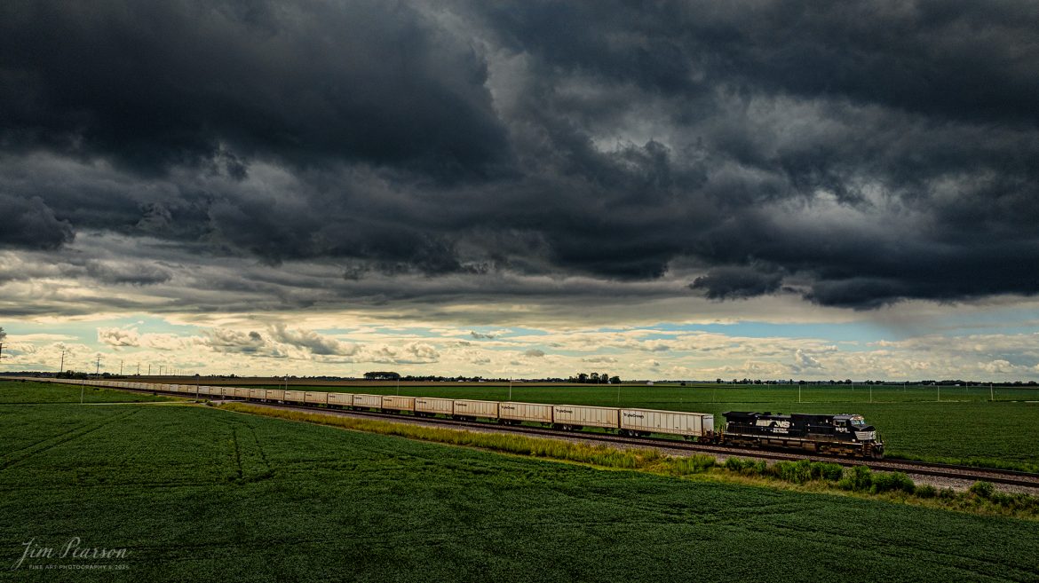 Norfolk Southern 9905 leads Triple Crown RoadRailer train as it stretches across the southern Illinois landscape running as eastbound NS 256 outside of Sidney, Illinois under cloudy weather along the NS Lafayette District on August 17th, 2024. The RoadRailer trains will become a thing of the past as of the weekend of 24-25th of August 2024, as the service will be discontinued and transitioned fully to standard double-stack trains.

According to Wikipedia: A RoadRailer is a trailer or semi-trailer that can be hauled on roads by a tractor unit and then by way of a fifth wheel coupling, operate in a unit train on railway lines. The RoadRailer system allows trailers to be pulled by locomotives without the use of flatcars, instead attaching trailers directly to bogies.

Triple Crown, a subsidiary of Norfolk Southern Railway, remains a user of RoadRailer transportation as of 2022. However, on August 12th, 2024, they announced the last RoadRailer Trains would be running the weekend of August 24 and 25, 2024. The RoadRailer trains will be replaced temporarily with Trailer on Flat Car (TOFC) service before transitioning fully to a standard double-stack container trains.

Tech Info: DJI Mavic 3 Classic Drone, RAW, 22mm, f/2.8, 1/2000, ISO 220.

#trainphotography #railroadphotography #trains #railways #trainphotographer #railroadphotographer #jimpearsonphotography #NorfolkSouthern #IllinoisRailroads