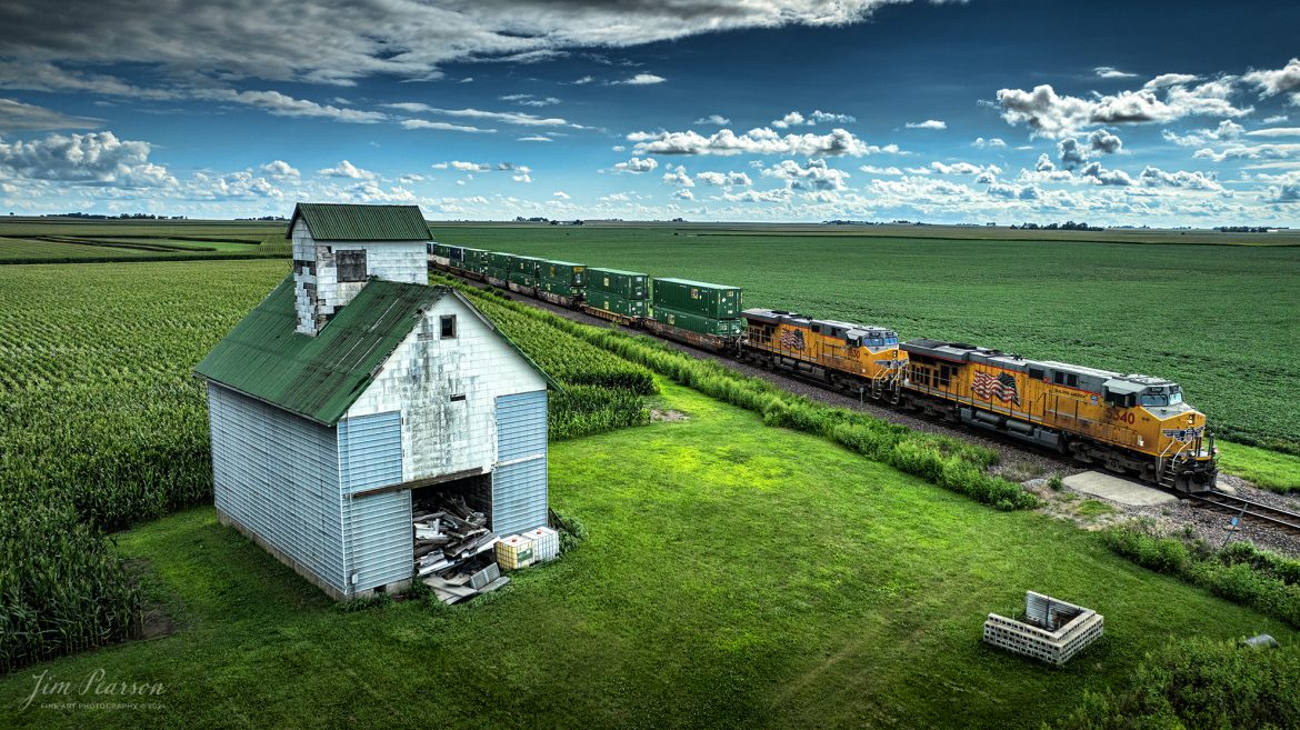 Union Pacific locomotives 5340 and 7630 lead a intermodal past one of many old barns that dart the landscape along the UP Villa Grove Subdivision as they head north at Sidney, Illinois on August 17th, 2024.

Tech Info: DJI Mavic 3 Classic Drone, RAW, 24mm, f/2.8, 1/3200, ISO 240.

#railroad #railroads #train #trains #bestphoto #railroadengines #picturesoftrains #picturesofrailway #bestphotograph #photographyoftrains #trainphotography #JimPearsonPhotography #trendingphoto #illinoistrains #unionpacificrailroad