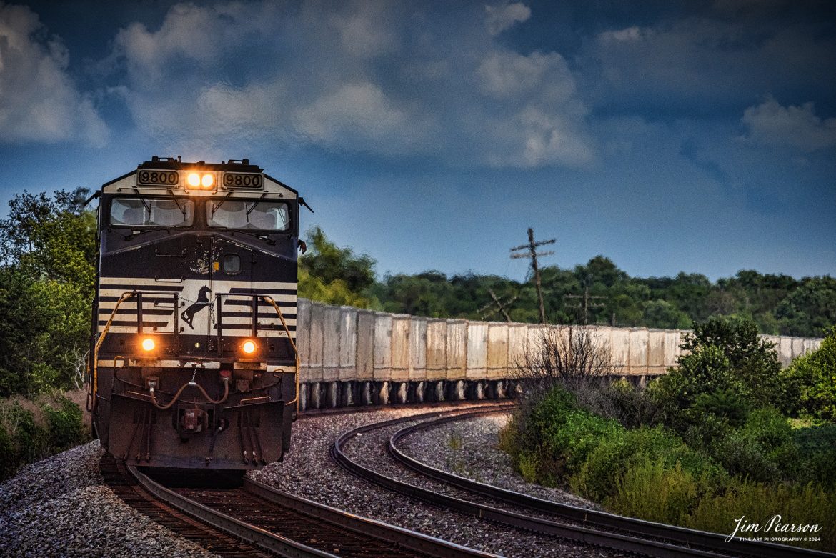 Norfolk Southern 9800 leads NS 255 Triple Crown RoadRailer train westbound as it passes through the curve outside of Sidney, Illinois on the NS Lafayette District on August 17th, 2024. The RoadRailer trains will become a thing of the past as of the 24-25th of August 2024 as the service will be discontinued and transitioned fully to standard double-stack trains.

According to Wikipedia: A RoadRailer is a trailer or semi-trailer that can be hauled on roads by a tractor unit and then by way of a fifth wheel coupling, operate in a unit train on railway lines. The RoadRailer system allows trailers to be pulled by locomotives without the use of flatcars, instead attaching trailers directly to bogies.

Triple Crown, a subsidiary of Norfolk Southern Railway, remains a user of RoadRailer transportation as of 2022. However on August 12th, 2024 they announced the last RoadRailer Trains would be running the weekend of August 24 and 25, 2024. The RoadRailer trains will be replaced temporarily with Trailer on Flat Car (TOFC) service before transitioning fully to a standard double-stack container trains.

Tech Info: Nikon D800, Sigma 150-600 @ 600mm, f/25, 1/350, ISO 1400.

#trainphotography #railroadphotography #trains #railways #trainphotographer #railroadphotographer #jimpearsonphotography #NorfolkSouthern #IllinoisRailroads