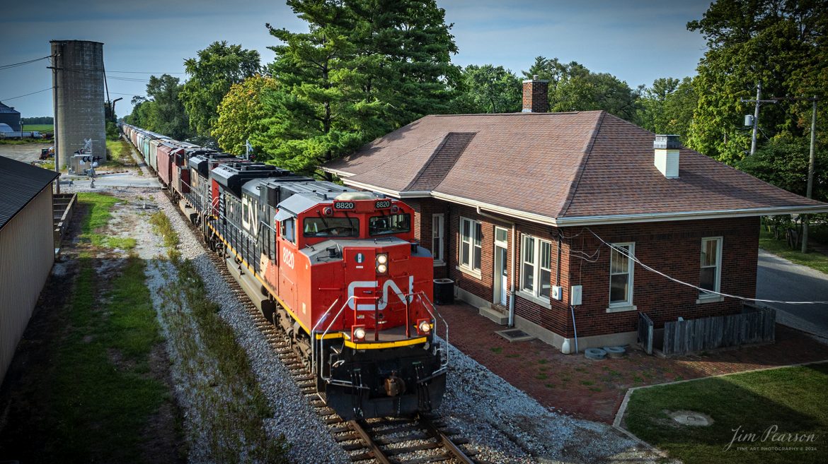 Canadian National 8820  leads a mixed freight as it pass the old Old Illinois Central Railroad Depot at Bethany, Illinois as they head south on the CN Peoria Subdivision on August 24th, 2024. 

According to waymarking.com, this station was built by the Illinois Central Railroad in 1923 and taken out of service in 1969. The building has seen several uses since that time and now appears vacant but in very good condition. Obvious additions have been made to the building's exterior that contrast sharply with its original architecture.

Tech Info: DJI Mavic 3 Classic Drone, RAW, 22mm, f/2.8, 1/2000, ISO 210.

#trainphotography #railroadphotography #trains #railways #trainphotographer #railroadphotographer #jimpearsonphotography #canadiannational #cn #IllinoisRailroads