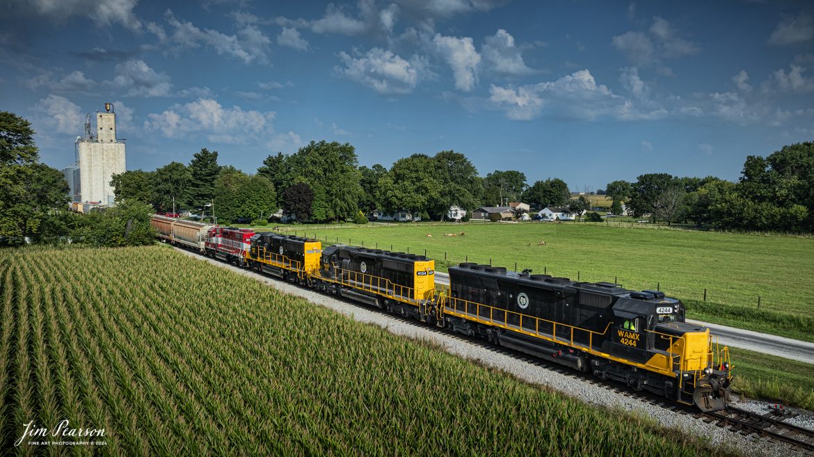 Decatur & Eastern Illinois Railroad (DERI) local with WAMX 4244, 4134, 5909 and Wisconsin & Southern 3872  leading the way, passes through La Place, Illinois on August 24th, 2024, as they head east to Terre Haute, Indiana (where they interchange with CSX) on the former CSX Danville Subdivision (now the DERI).

According to Wikipedia: The Decatur & Eastern Illinois Railroad (reporting mark DREI) is an American regional railroad that is a subsidiary of Watco Companies operating in eastern Illinois and western Indiana.

In January 2018, CSX Transportation announced that it was seeking offers to buy the Decatur Subdivision and the Danville Secondary Subdivision as part of a system-wide sale of low-traffic routes, and in July, Watco, via the DREI, was identified as the winning bidder. Following regulatory approval from the Surface Transportation Board, The DREI began operations on September 9, 2018.

The DREI operates two intersecting routes totaling 126.7 miles (203.9 km)—the former Decatur Subdivision between Montezuma, Indiana and Decatur, Illinois, and the former Danville Subdivision between Terre Haute, Indiana and Olivet, Illinois. It interchanges traffic with CSX, the Eastern Illinois Railroad, the Norfolk Southern Railway, the Canadian National Railway, and the Union Pacific Railroad. The railroad is headquartered in Decatur, Illinois.

Tech Info: DJI Mavic 3 Classic Drone, RAW, 22mm, f/2.8, 1/1600, ISO 100.

#trainphotography #railroadphotography #trains #railways #trainphotographer #railroadphotographer #jimpearsonphotography #DecaturandEasternRailroad #IllinoisRailroads