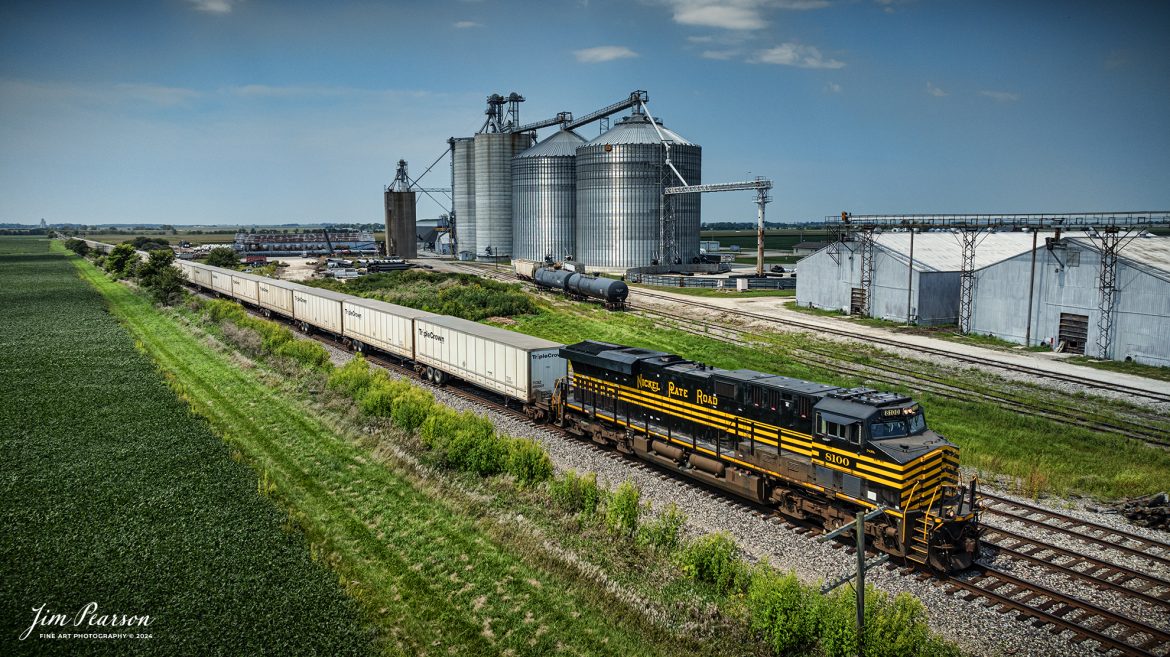 Norfolk Southern Nickel Plate Road Heritage Unit 8100 leads Triple Crown RoadRailer train NS 256 eastbound as it passes the United Prairie and Premier Cooperative grain complexes at Tolono, Illinois on August 24th, 2024, as they head east on the NS Lafayette District. 

The NS RoadRailer trains are now a thing of the past as the last one ran yesterday, 25th of August 2024, and the service has now been discontinued and the will transition fully to standard double-stack trains.

According to Wikipedia: A RoadRailer is a trailer or semi-trailer that can be hauled on roads by a tractor unit and then by way of a fifth wheel coupling, operate in a unit train on railway lines. The RoadRailer system allows trailers to be pulled by locomotives without the use of flatcars, instead attaching trailers directly to bogies.

Triple Crown, a subsidiary of Norfolk Southern Railway, remains a user of RoadRailer transportation as of 2022. However, on August 12th, 2024, they announced the last RoadRailer Trains would be running the weekend of August 24 and 25, 2024. The RoadRailer trains will be replaced temporarily with Trailer on Flat Car (TOFC) service before transitioning fully to a standard double-stack container trains.

Tech Info: DJI Mavic 3 Classic Drone, RAW, 22mm, f/2.8, 1/2000, ISO 100.

#trainphotography #railroadphotography #trains #railways #trainphotographer #railroadphotographer #jimpearsonphotography #NorfolkSouthern #IllinoisRailroads