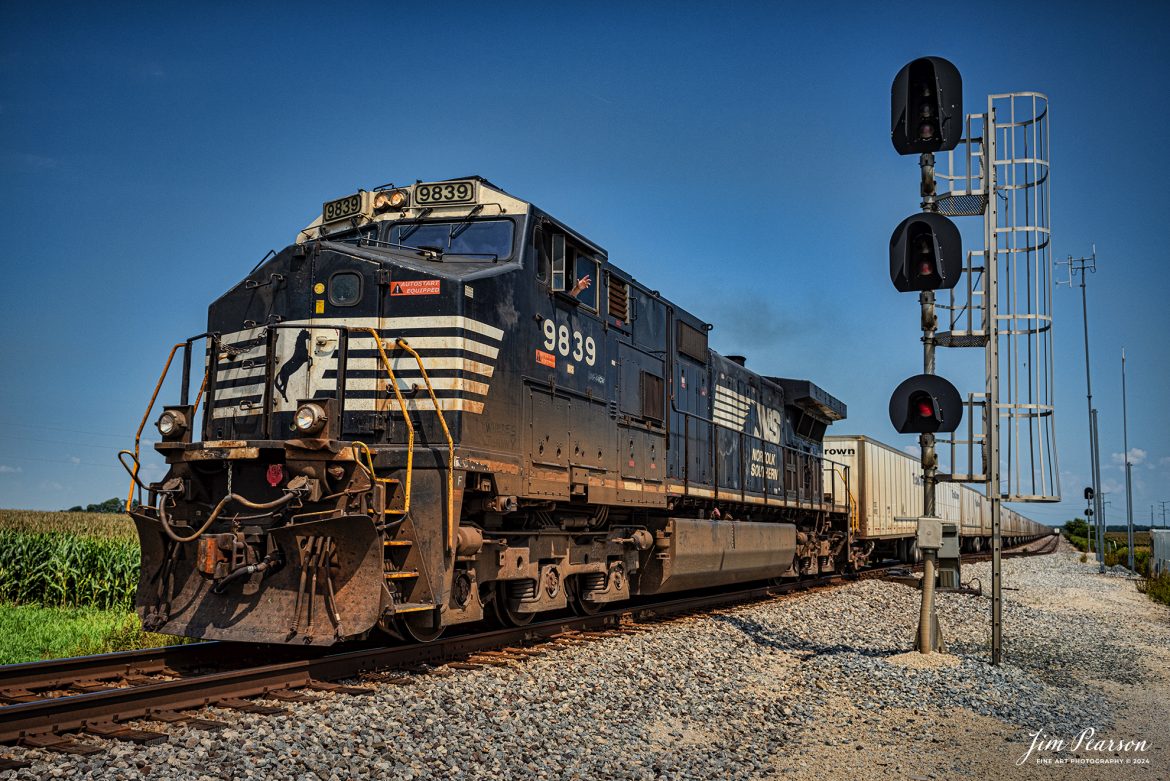 Norfolk Southern 9839 leads Triple Crown RoadRailer train NS 255 westbound as the conductor gives a friendly wave, as they pass their counterpart NS 256,  at Tolono, Illinois on August 24th, 2024, as they head west on the NS Lafayette District. 

The NS RoadRailer trains are now a thing of the past as the last one ran yesterday, 25th of August 2024, and the service has now been discontinued and they will transition fully to standard double-stack trains.

According to Wikipedia: A RoadRailer is a trailer or semi-trailer that can be hauled on roads by a tractor unit and then by way of a fifth wheel coupling, operate in a unit train on railway lines. The RoadRailer system allows trailers to be pulled by locomotives without the use of flatcars, instead attaching trailers directly to bogies.

Triple Crown, a subsidiary of Norfolk Southern Railway, remains a user of RoadRailer transportation as of 2022. However, on August 12th, 2024, they announced the last RoadRailer Trains would be running the weekend of August 24 and 25, 2024. The RoadRailer trains will be replaced temporarily with Trailer on Flat Car (TOFC) service before transitioning fully to a standard double-stack container trains.

Tech Info: Nikon D810, RAW, Nikon 24-70 @ 26mm, f/5, 1/1600, ISO 100.

#trainphotography #railroadphotography #trains #railways #trainphotographer #railroadphotographer #jimpearsonphotography #NikonD810 #NorfolkSouthern