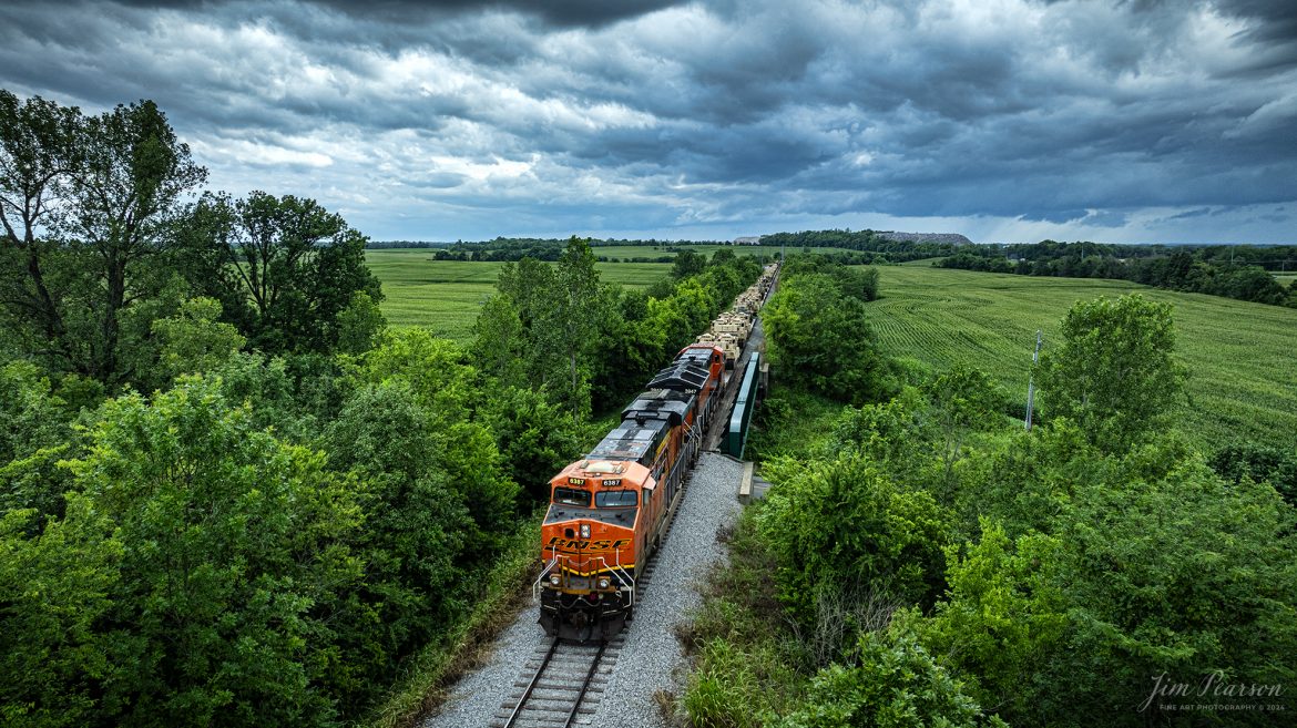 BNSF 6387 and 3947 lead CSX S577 as the crew backs a loaded military train onto the Ft. Campbell lead at Hopkinsville, Ky, from the CSX Henderson Subdivision on July 9th, 2024, under threatening skies during a Tornado Warning spawned by the remnants of Hurricane Alberto. Fellow railfan Brian Caswell and I sat for a couple hours hoping that Ft. Campbell would show up to carry the equipment onto the base, but unfortunately it didn’t happen. Despite the warnings here very little rain fell and most of the tornados spawned in our area were more to the northeast up in Indiana.

Tech Info: DJI Mavic 3 Classic Drone, RAW, 22mm, f/2.8, 1/1000, ISO 210.

#railroad #railroads #train #trains #bestphoto #railroadengines #picturesoftrains #picturesofrailway #bestphotograph #photographyoftrains #trainphotography #JimPearsonPhotography #trendingphoto #militarytrains #stormyweather