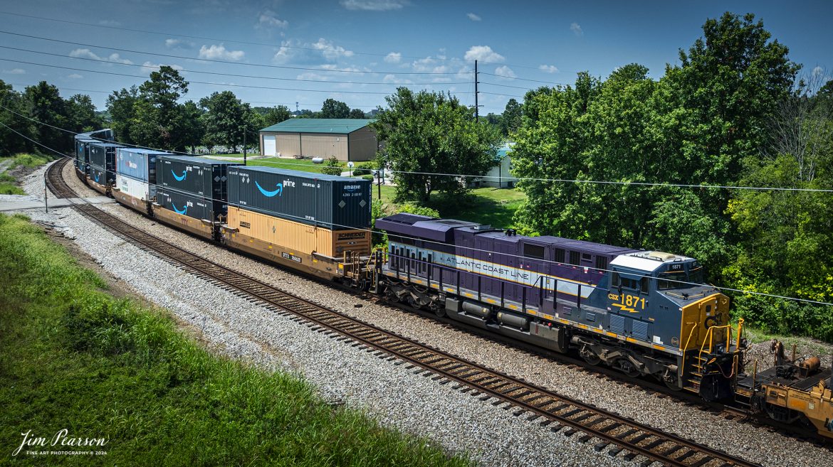 Atlantic Coast Line Heritage Unit CSXT 1871 runs as a mid-train DPU unit as it heads south at Hopkinsville, Kentucky on July 12th, 2024, on the CSX Henderson Subdivision. This was my first catch on this heritage unit and while I would prefer it to be leading, I didn’t want to pass up a chance of catching this unit for my first time!

According to a CSX Press Release: November 29, 2023 - The CSX fleet of heritage locomotives is continuing to grow with the introduction of a unit painted in a custom design honoring the Atlantic Coast Line Railroad.

Designated CSX 1871, the seventh locomotive in the heritage series was unveiled at the CSX Locomotive Shop in Waycross, Georgia, which has designed and applied the paint schemes for all the heritage units. The latest in the series features the modern CSX design on the head end, transitioning to historic paint scheme and logo of the Atlantic Coast Line at the rear.

The Atlantic Coast Line name first appeared in 1871, and the American Coast Line Railroad (ACL) was officially incorporated in 1900. The ACL extended from Georgia to Richmond, Virginia, and later expanded into Florida. In 1960, the company opened a new headquarters building in Jacksonville, which continues as CSX headquarters to this day. The ACL merged with the Seaboard Air Line Railroad in 1967 to form the Seaboard Coast Line, which later became part of CSX.

“We do a lot of research on the colors and the schemes just to make sure that we get it right,” said Jeromy Hutchison, CSX carman painter. “We want to make sure we do our heritage justice.”

CSX 1871 will carry the ACL colors in service across the 20,000-mile CSX network, reinforcing employee pride in the history of the railroad that continues to move the nation’s economy with safe, reliable and sustainable rail-based transportation services.

Tech Info: DJI Mavic 3 Classic Drone, RAW, 22mm, f/2.8, 1/2500, ISO 110.

#railroad #railroads #train #trains #bestphoto #railroadengines #picturesoftrains #picturesofrailway #bestphotograph #photographyoftrains #trainphotography #JimPearsonPhotography #trendingphoto #csxheritagelocomotive #AtlanticCoasLine