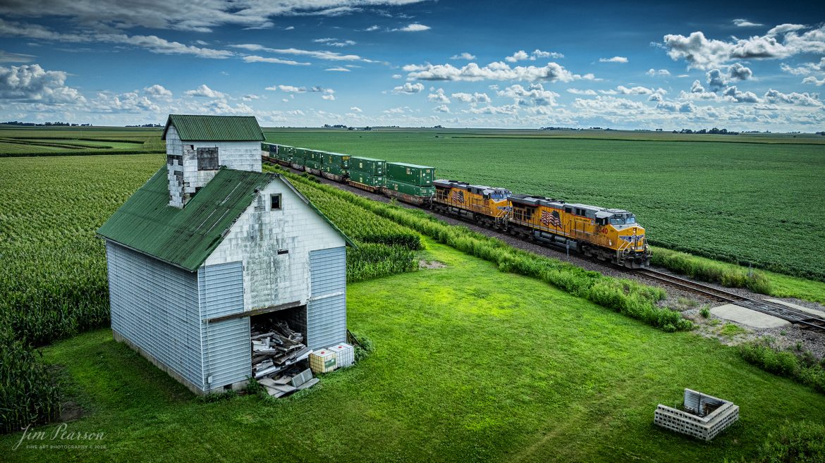 Union Pacific locomotives 5340 and 7630 lead a intermodal past one of many old corn cribs that dart the landscape along the UP Villa Grove Subdivision as they head north at Sidney, Illinois on August 17th, 2024.

Tech Info: DJI Mavic 3 Classic Drone, RAW, 24mm, f/2.8, 1/3200, ISO 240.

#railroad #railroads #train #trains #bestphoto #railroadengines #picturesoftrains #picturesofrailway #bestphotograph #photographyoftrains #trainphotography #JimPearsonPhotography #trendingphoto #illinoistrains #unionpacificrailroad