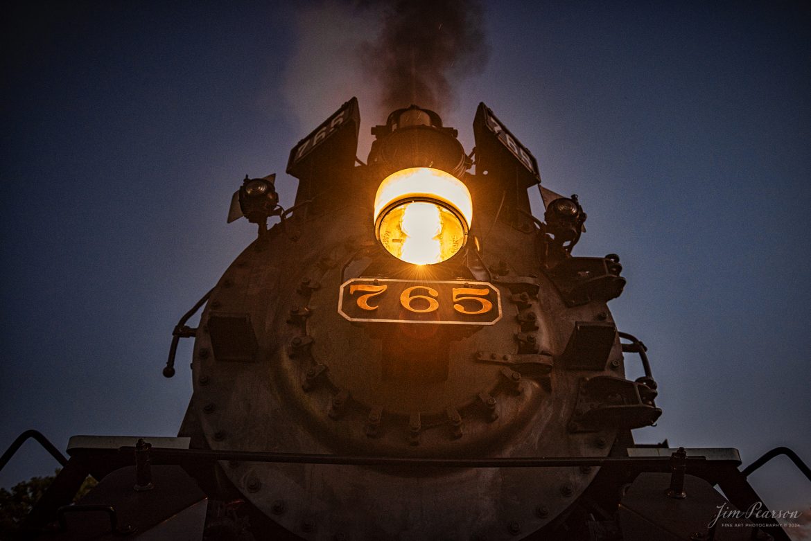 An evening portrait of Steam locomotive Nickel Plate 765 as it sits next to the station at Pleasant Lake, Indiana during a night photo shoot as part of Indiana Rail Experience’s Rolling Victory Weekend on August 31st, 2024.

According to their website: Rolling Victory was a three-day living history event celebrating American military, railroad, and home front history featuring vintage train rides, World War II reenactors, battles, a big band orchestra, and an immersive and educational experience for all ages in Pleasant Lake, Indiana.

Tech Info: Nikon D810, RAW, Nikon 24-70 @ 24mm, f/2.8, 1/30, ISO 400.

#railroad #railroads #train, #trains #railway #railway #steamtrains #railtransport #railroadengines #picturesoftrains #picturesofrailways #besttrainphotograph #bestphoto #photographyoftrains #bestsoldpicture #JimPearsonPhotography #steamtrains #nkp765 #passengertrains