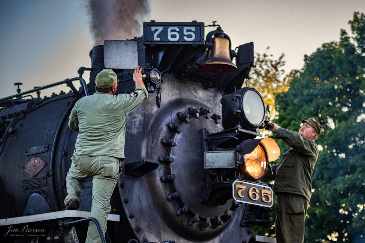 August 31st, 2024, Reenactor’s Tyler Kostyla on the right and Ken Hoelscher on the left clean the lamps on Nickel Plate Steam Locomotive 765 at Pleasant Lake, IN during Indiana Rail Experience’s Rolling Victory Weekend. During WWII military personnel actually worked on 765. 

According to their website: Rolling Victory was a three-day living history event celebrating American military, railroad, and home front history featuring vintage train rides, World War II reenactors, battles, a big band orchestra, and an immersive and educational experience for all ages in Pleasant Lake, Indiana.

Tech Info: Nikon D810, RAW, Nikon 24-70 @ 70mm, f/2.8, 1/640, ISO 560.

#railroad #railroads #train, #trains #railway #railway #steamtrains #railtransport #railroadengines #picturesoftrains #picturesofrailways #besttrainphotograph #bestphoto #photographyoftrains #bestsoldpicture #JimPearsonPhotography #steamtrains #nkp765 #passengertrains