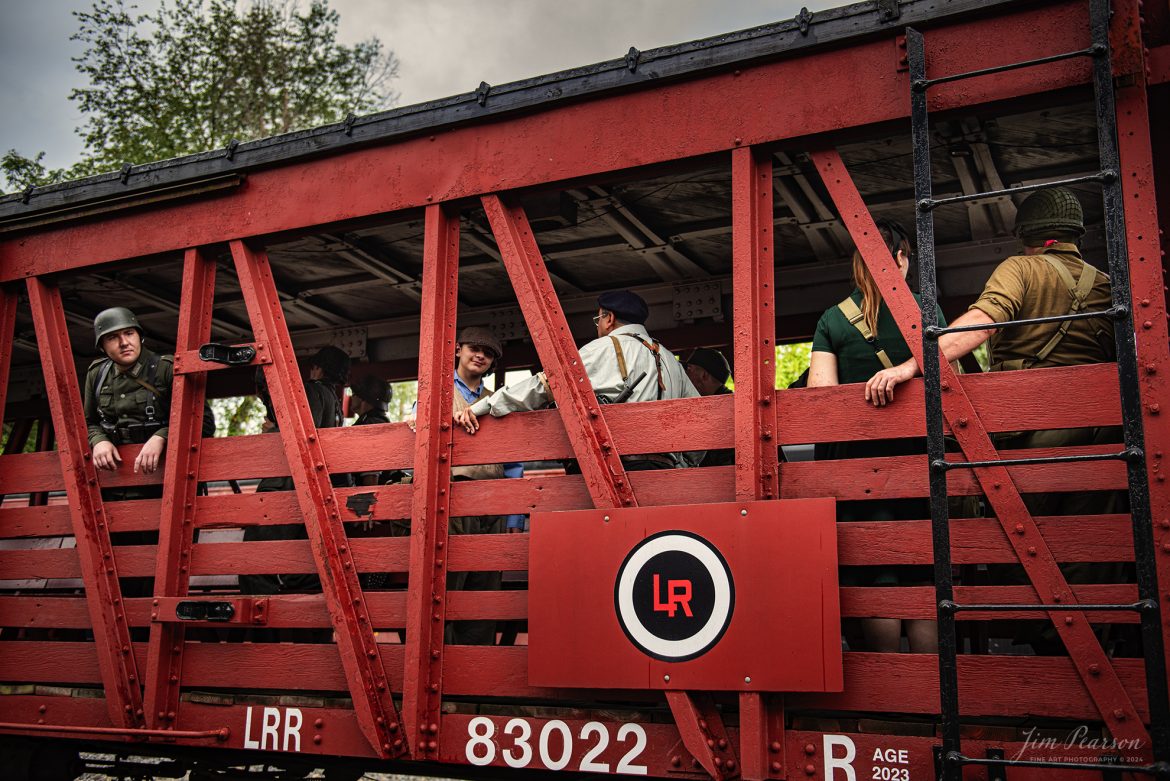 Military reenactors from the German, American and French Resistance prepare to depart on “The Battle Train” from Pleasant Lake, IN, on August 31st, 2024, where they were transported to the “battlefield” to take part in a mock battle as part of the Rolling Victory Weekend. This was the first time the event hosted battles during the weekend event and passengers and reenactors were moved via this train to participate and watch the battle.

According to their website: Rolling Victory was a three-day living history event celebrating American military, railroad, and home front history featuring vintage train rides, World War II reenactors, battles, a big band orchestra, and an immersive and educational experience for all ages in Pleasant Lake, Indiana.

Tech Info: Nikon D810, RAW, Nikon 24-70 @ 34mm, f/2.8, 1/500, ISO 280.

#railroad #railroads #train, #trains #railway #railway #steamtrains #railtransport #railroadengines #picturesoftrains #picturesofrailways #besttrainphotograph #bestphoto #photographyoftrains #bestsoldpicture #JimPearsonPhotography #steamtrains #nkp765 #passengertrains