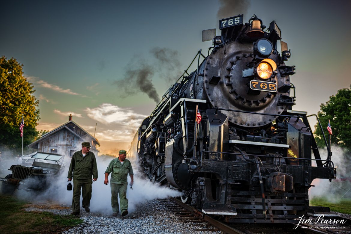 Military reenactors Tyler Kostyla, left, and Ken Hoelscher on the pass-through steam from NKP 765 during the evening/night photo shoot at Pleasant Lake, IN, on August 31st, 2024, during the Rolling Victory Weekend. During World War II there were military crews that ran and maintained this locomotive, from what I’m told.

According to their website: Rolling Victory was a three-day living history event celebrating American military, railroad, and home front history featuring vintage train rides, World War II reenactors, battles, a big band orchestra, and an immersive and educational experience for all ages in Pleasant Lake, Indiana.

Tech Info: Nikon D810, RAW, Nikon 24-70 @ 29mm, f/6.3, 1/200, ISO 200.

#railroad #railroads #train, #trains #railway #railway #steamtrains #railtransport #railroadengines #picturesoftrains #picturesofrailways #besttrainphotograph #bestphoto #photographyoftrains #bestsoldpicture #JimPearsonPhotography #steamtrains #nkp765 #passengertrains