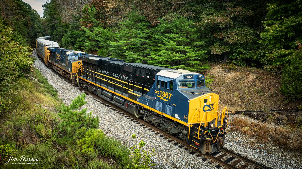 CSX I025 with CSX Seaboard Coast Line Railroad Heritage Unit (SCL), 1967 leading heads south as it passes through the Sand cut, north of Crofton, Kentucky on the CSX Henderson Subdivision, on September 13th, 2024. 

According to a CSX Press Release: June 6, 2024 - CSX has released a new heritage locomotive, the P&LE 1875, paying tribute to the storied Pittsburgh & Lake Erie Railroad (P&LE). The 15th in CSX’s heritage locomotive series, this new addition to the company’s fleet not only celebrates the rich history of P&LE but also marks a significant milestone in CSX's ongoing commitment to honoring the legacies of America's historic railroads.

The Pittsburgh & Lake Erie Railroad was established in 1875 with a primary mission of transporting essential industrial materials such as coal, coke, iron ore, limestone, and steel among the bustling industrial hubs of the region. 

“It’s mainline connected Pittsburgh, Pennsylvania with Youngstown, Ohio and Connellsville, Pennsylvania. It did not actually reach Lake Erie until 1976,” explained Tim Music, a carman painter at the CSX Waycross Locomotive Shop where the unit was produced.

Despite its relatively modest route mileage, the P&LE Railroad earned the nickname "Little Giant" due to the enormous volume of heavy tonnage it moved. This impressive capability drew significant attention and by 1887, the P&LE became a subsidiary of the dominant New York Central Railroad. Under this new ownership, the P&LE enjoyed substantial improvements to its tracks and added capacity for passenger services, further enhancing its regional significance.

Over time, P&LE expanded by leasing branches from smaller railroads. These extensions included lines southeast along the Monongahela River through Homestead and McKeesport, and along the Youghiogheny River to Connellsville, where it connected with the Western Maryland Railway.

Tech Info: DJI Mavic 3 Classic Drone, RAW, 22mm, f/2.8, 1/400, ISO 100.

#railroad #railroads #train, #trains #railway #railway #steamtrains #railtransport #railroadengines #picturesoftrains #picturesofrailways #besttrainphotograph #bestphoto #photographyoftrains #steamtrainphotography #CSXPLEheritageunit #bestsoldpicture #JimPearsonPhotography #csxheritagelocomotive #onecsx