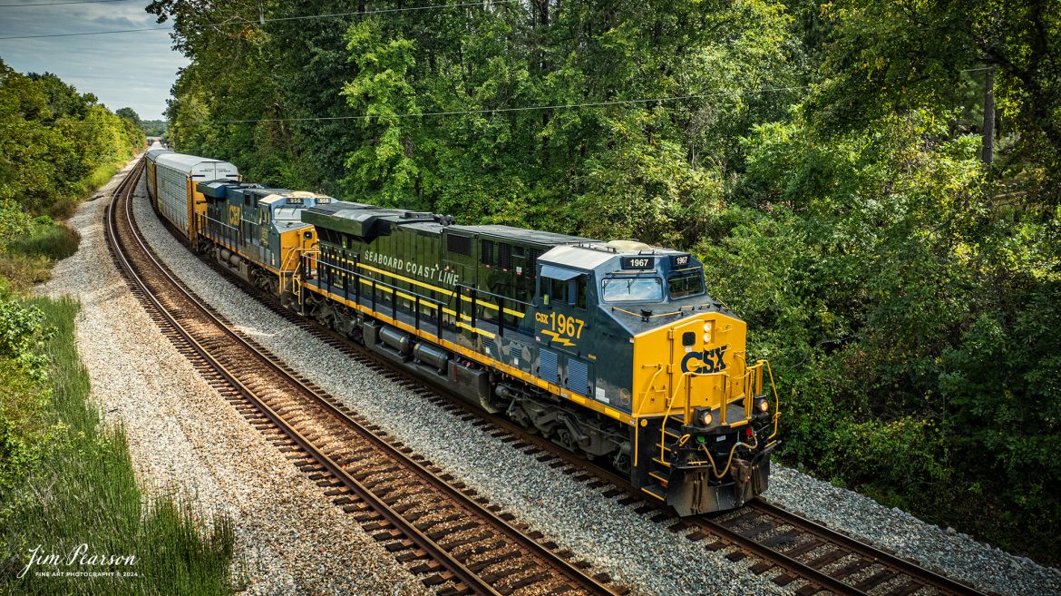 CSX I025 with CSX Seaboard Coast Line Railroad Heritage Unit (SCL), 1967 leading heads south at Nortonville, Kentucky on the CSX Henderson Subdivision, on September 13th, 2024. 

According to a CSX Press Release: June 6, 2024 - CSX has released a new heritage locomotive, the P&LE 1875, paying tribute to the storied Pittsburgh & Lake Erie Railroad (P&LE). The 15th in CSX’s heritage locomotive series, this new addition to the company’s fleet not only celebrates the rich history of P&LE but also marks a significant milestone in CSX's ongoing commitment to honoring the legacies of America's historic railroads.

The Pittsburgh & Lake Erie Railroad was established in 1875 with a primary mission of transporting essential industrial materials such as coal, coke, iron ore, limestone, and steel among the bustling industrial hubs of the region. 

“It’s mainline connected Pittsburgh, Pennsylvania with Youngstown, Ohio and Connellsville, Pennsylvania. It did not actually reach Lake Erie until 1976,” explained Tim Music, a carman painter at the CSX Waycross Locomotive Shop where the unit was produced.

Despite its relatively modest route mileage, the P&LE Railroad earned the nickname "Little Giant" due to the enormous volume of heavy tonnage it moved. This impressive capability drew significant attention and by 1887, the P&LE became a subsidiary of the dominant New York Central Railroad. Under this new ownership, the P&LE enjoyed substantial improvements to its tracks and added capacity for passenger services, further enhancing its regional significance.

Over time, P&LE expanded by leasing branches from smaller railroads. These extensions included lines southeast along the Monongahela River through Homestead and McKeesport, and along the Youghiogheny River to Connellsville, where it connected with the Western Maryland Railway.

Tech Info: DJI Mavic 3 Classic Drone, RAW, 22mm, f/2.8, 1/1600, ISO 230.

#railroad #railroads #train, #trains #railway #railway #steamtrains #railtransport #railroadengines #picturesoftrains #picturesofrailways #besttrainphotograph #bestphoto #photographyoftrains #steamtrainphotography #CSXPLEheritageunit #bestsoldpicture #JimPearsonPhotography #csxheritagelocomotive #onecsx