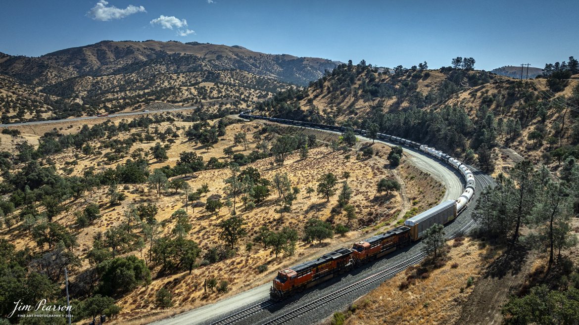 September 19th, 2024, BNSF tank train heads south through the mountains toward Tehachapi the loop at Woodford, California, on the Union Pacific Mojave Subdivision.

Tech Info: DJI Mavic 3 Classic Drone, RAW, 24mm, f/2.8, 1/4000, ISO 200.

#railroad #railroads #train, #trains #railway #railway #steamtrains #railtransport #railroadengines #picturesoftrains #picturesofrailways #besttrainphotograph #bestphoto #photographyoftrains #bestsoldpicture #JimPearsonPhotography #trainsfromtheair #trainsfromadrone