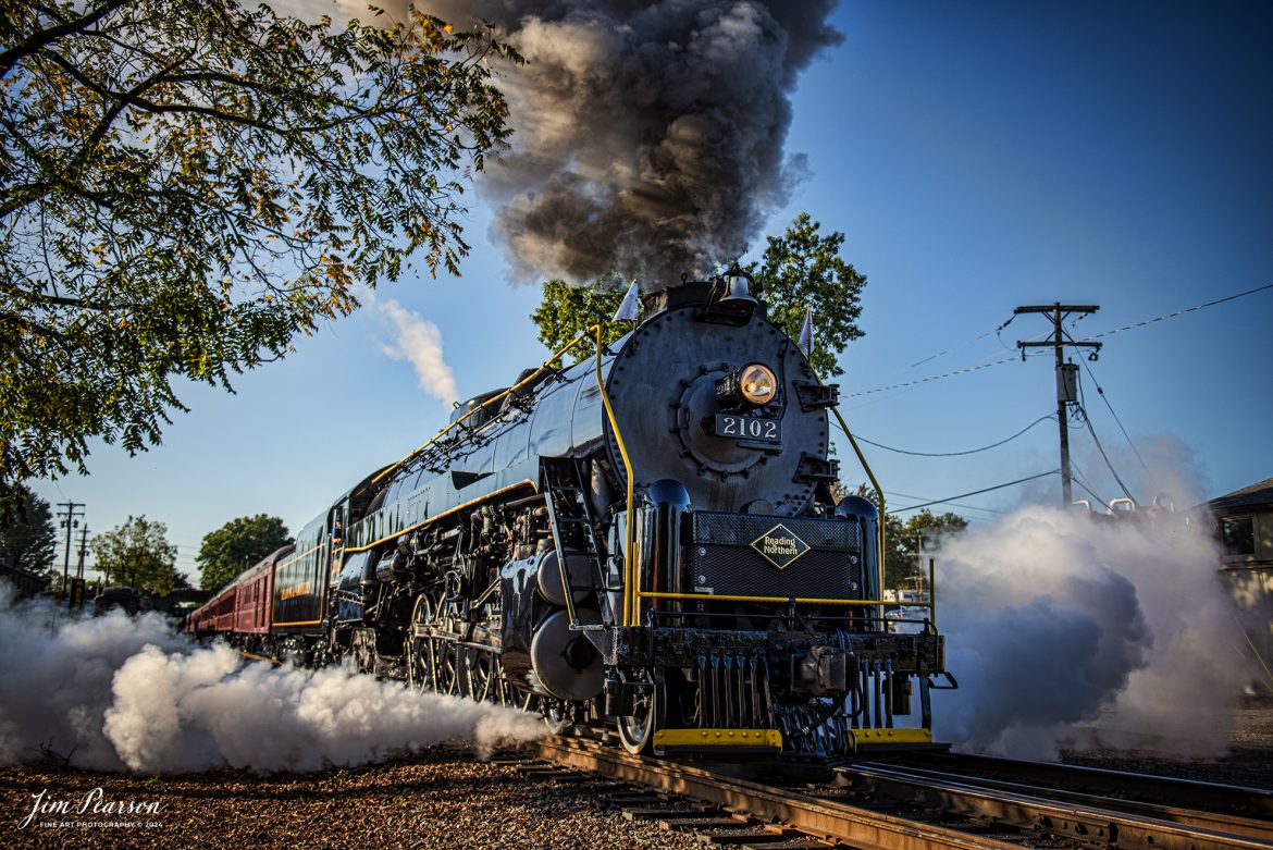 Reading Blue Mountain & Northern Railroad steam locomotive 2102 pulls away from the outer station at Reading, Pennsylvania on October 5th, 2024,during its first day of the year of pulling Fall Foliage Excursions.

According to their website: The Reading Company T-1 class #2102 was built in the Reading’s own locomotive shops in 1945. With drivers of 70” diameter, it weighs 404 tons, and its tender holds up to 26 tons of coal, and up to 19,000 gallons of water. After the Reading Steam era was over, the Reading Company used 2102 for the Reading Rambles on several different excursions. The 2102 has had many different owners since it was retired by the Reading Railroad. It is one of only four to survive. The other remaining locomotives are the 2100, 2101, and 2124.

The Blue Mountain and Reading Railroad purchased the 2102 in 1987, and it ran on the Temple to South Hamburg line into the early 1990’s. Once the Blue Mountain and Reading Railroad became the Reading Blue Mountain & Northern, the 2102 ran over Reading & Northern’s rails for a short time before it was removed from service in the early 1990’s. 

In 2022, steam locomotive 2102 reentered service on the Reading & Northern. The locomotive has been used actively to pull both passenger excursions and revenue freight trains.

Tech Info: Nikon D810, RAW, Nikon 24-70 @ 32mm, 2.8, 1/2000, ISO 140.

#steamtrains #besttrainphotograph #JimPearsonPhotography #RBNRR