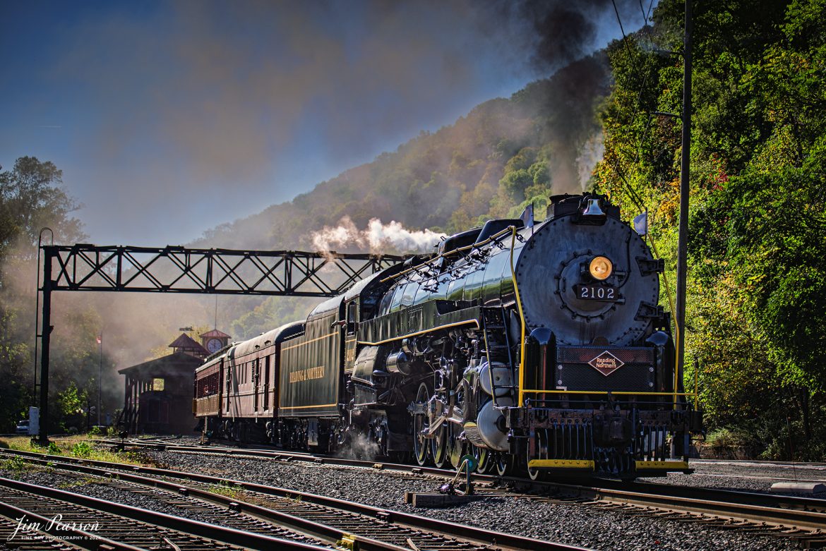 Reading Blue Mountain & Northern Railroad steam locomotive 2102 pulls away from the station at at Port Clinton, Pennsylvania on October 5th, 2024,during its first day of the year of pulling Fall Foliage Excursions.

According to their website: The Reading Company T-1 class #2102 was built in the Reading’s own locomotive shops in 1945. With drivers of 70” diameter, it weighs 404 tons, and its tender holds up to 26 tons of coal, and up to 19,000 gallons of water. After the Reading Steam era was over, the Reading Company used 2102 for the Reading Rambles on several different excursions. The 2102 has had many different owners since it was retired by the Reading Railroad. It is one of only four to survive. The other remaining locomotives are the 2100, 2101, and 2124.

The Blue Mountain and Reading Railroad purchased the 2102 in 1987, and it ran on the Temple to South Hamburg line into the early 1990’s. Once the Blue Mountain and Reading Railroad became the Reading Blue Mountain & Northern, the 2102 ran over Reading & Northern’s rails for a short time before it was removed from service in the early 1990’s. 

In 2022, steam locomotive 2102 reentered service on the Reading & Northern. The locomotive has been used actively to pull both passenger excursions and revenue freight trains.

Tech Info: Nikon D810, RAW, Nikon 70-300 @ 70mm, 5.6, 1640, ISO 64.

#steamtrains #besttrainphotograph #JimPearsonPhotography #RBNRR