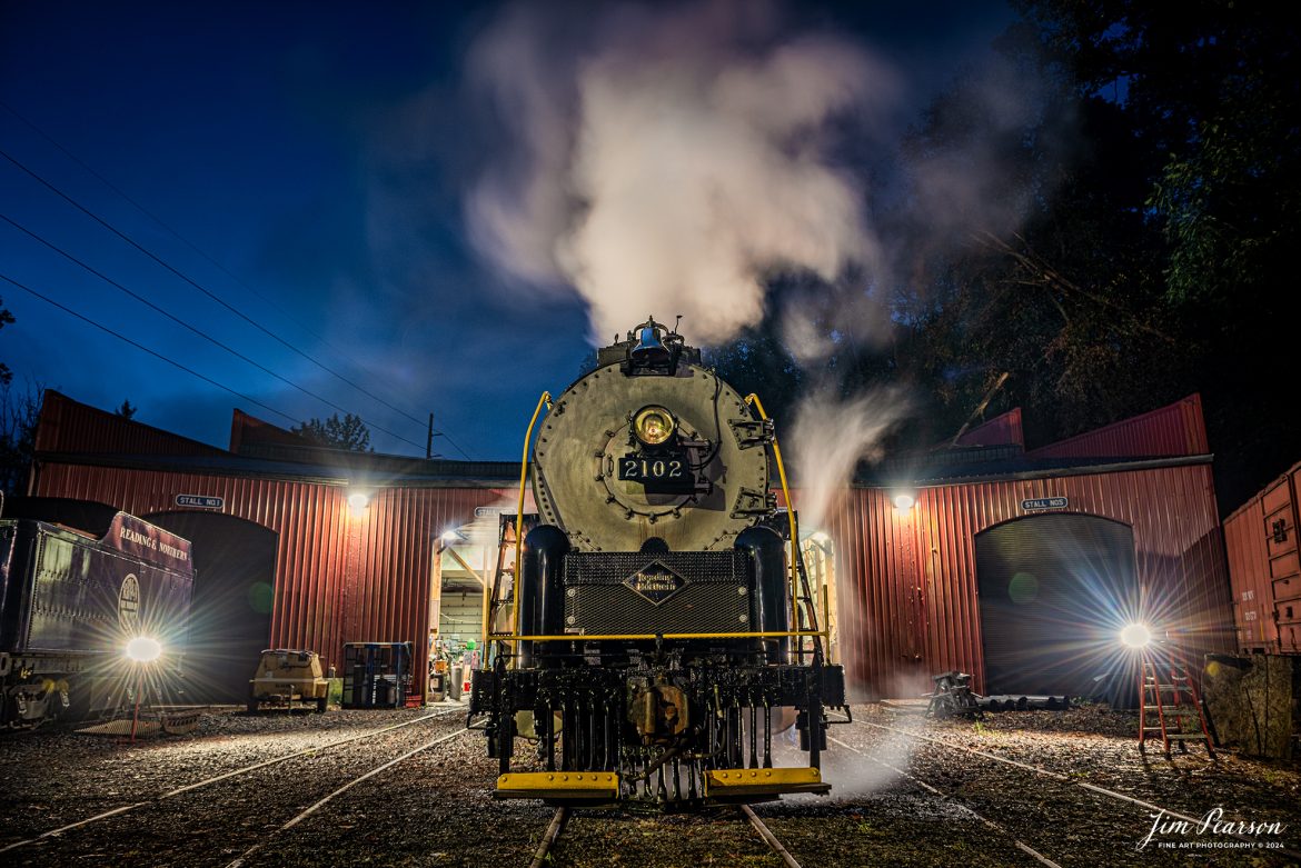 Reading Blue Mountain & Northern Railroad steam locomotive 2102 sits outside the engine house as dawn begins at Port Clinton, Pennsylvania on October 5th, 2024, as it waits to begin its first day of the year of pulling Fall Foliage Excursions.

According to their website: The Reading Company T-1 class #2102 was built in the Reading’s own locomotive shops in 1945. With drivers of 70” diameter, it weighs 404 tons, and its tender holds up to 26 tons of coal, and up to 19,000 gallons of water. After the Reading Steam era was over, the Reading Company used 2102 for the Reading Rambles on several different excursions. The 2102 has had many different owners since it was retired by the Reading Railroad. It is one of only four to survive. The other remaining locomotives are the 2100, 2101, and 2124.

The Blue Mountain and Reading Railroad purchased the 2102 in 1987, and it ran on the Temple to South Hamburg line into the early 1990’s. Once the Blue Mountain and Reading Railroad became the Reading Blue Mountain & Northern, the 2102 ran over Reading & Northern’s rails for a short time before it was removed from service in the early 1990’s. 

In 2022, steam locomotive 2102 reentered service on the Reading & Northern. The locomotive has been used actively to pull both passenger excursions and revenue freight trains.

Tech Info: Nikon D810, RAW, Nikon 24-70 @ 24mm, 5.6, 2.5 seconds, ISO 200.

#railroad #railroads #train, #trains #railway #railway #steamtrains #railtransport #railroadengines #picturesoftrains #picturesofrailways #besttrainphotograph #bestphoto #photographyoftrains #bestsoldpicture #JimPearsonPhotography #RBNRR