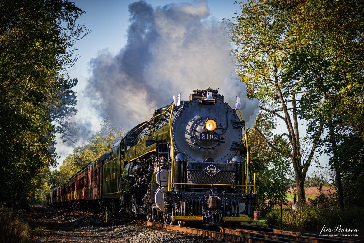 Reading Blue Mountain & Northern Railroad steam locomotive 2102 pulls through the countryside on October 5th, 2024, during its first day of the year of pulling Fall Foliage Excursions, as it heads for Jim Thorpe, Pennsylvania.

According to their website: The Reading Company T-1 class #2102 was built in the Reading’s own locomotive shops in 1945. With drivers of 70” diameter, it weighs 404 tons, and its tender holds up to 26 tons of coal, and up to 19,000 gallons of water. After the Reading Steam era was over, the Reading Company used 2102 for the Reading Rambles on several different excursions. The 2102 has had many different owners since it was retired by the Reading Railroad. It is one of only four to survive. The other remaining locomotives are the 2100, 2101, and 2124.

The Blue Mountain and Reading Railroad purchased the 2102 in 1987, and it ran on the Temple to South Hamburg line into the early 1990’s. Once the Blue Mountain and Reading Railroad became the Reading Blue Mountain & Northern, the 2102 ran over Reading & Northern’s rails for a short time before it was removed from service in the early 1990’s. 

In 2022, steam locomotive 2102 reentered service on the Reading & Northern. The locomotive has been used actively to pull both passenger excursions and revenue freight trains.

Tech Info: Nikon D810, RAW, Nikon 70-300 @ 78mm,  1/640, f/4.5, ISO 180.

#steamtrains #besttrainphotograph #JimPearsonPhotography #RBNRR