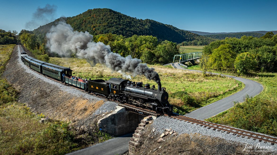 East Broad Top (EBT) steam locomotive #16 pulls a passenger train out of Rockhill Furnace, Pennsylvania on October 6th, 2024, on a beautiful fall morning.

According to the East Broad Top Website: Locomotive #16 was built in 1916 by the Baldwin Locomotive Works.

Entering the age of modern steam in 1916, the EBT received its first of three large Mikados. Unlike the previous three smaller locomotives, #16 came with superheaters, piston valves, and Southern valve gear. One story mentions #16 pulled 60 empty hoppers from Mt. Union to Rockhill in one train, literally clearing out the yard. #16 underwent an overhaul in 1955 and made only a handful of trips in early 1956 before the railroad shut down an overhaul when the EBT shut down. On February 1, 2023, the locomotive returned to service.

Tech Info: DJI Mavic 3 Classic Drone, RAW, 24mm, f/2.8, 1/1600, ISO 120.

#steamtrains #JimPearsonPhotography #trainsfromtheair #EastBroadTop