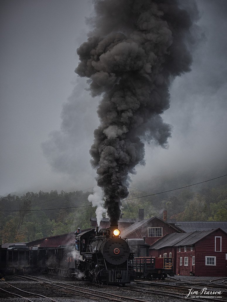 East Broad Top (EBT) steam locomotive #16 pulls a mixed freight through the early morning fog as they pull through the yard at Rockhill Furnace, Pennsylvania on October 6th, 2024, during the museum’s Friends of the East Broad top event.

According to the East Broad Top Website: Locomotive #16 was built in 1916 by the Baldwin Locomotive Works.

Entering the age of modern steam in 1916, the EBT received its first of three large Mikados. Unlike the previous three smaller locomotives, #16 came with superheaters, piston valves, and Southern valve gear. One story mentions #16 pulled 60 empty hoppers from Mt. Union to Rockhill in one train, literally clearing out the yard. #16 underwent an overhaul in 1955 and made only a handful of trips in early 1956 before the railroad shut down. On February 1, 2023, the locomotive returned to service.

Tech Info: Nikon D810, RAW, Nikon 70-300 @110mm, f/4.8, 1/250, ISO 320.

steam locomotive, train, railways, vintage, smoke, green hillside, sunlight, iron bridge, transportation, travel, photography of trains, train photography, Jim Pearson Photography, trending photo, East Broad Top Railroad, steam train