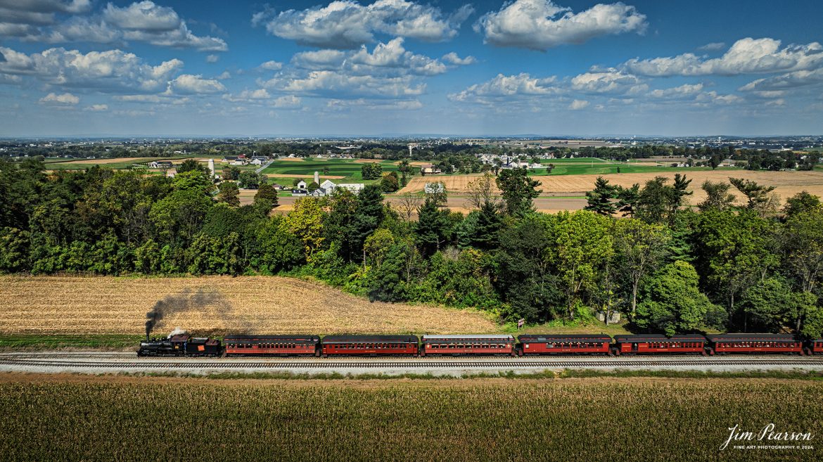 Canadian National 89 pulls a passenger train through the countryside on the Strasburg Railroad as It heads back to the depot at Strasburg, PA, on October 7th, 2024.

According to Wikipedia: The Strasburg Rail Road (reporting mark SRC) is a heritage railroad and the oldest continuously operating standard-gauge railroad in the western hemisphere, as well as the oldest public utility in the Commonwealth of Pennsylvania. Chartered in 1832, the Strasburg Rail Road Company is today a heritage railroad offering excursion trains hauled by steam locomotives on 4.02 mi of track in Pennsylvania Dutch Country, as well as providing contract railroad mechanical services, and freight service to area shippers. The railroad's headquarters are outside Strasburg, Pennsylvania.

Tech Info: DJI Mavic 3 Classic Drone, RAW, 24mm, f/2.8, 1/2000, ISO 100.

#photographyoftrains #bestsoldpicture #JimPearsonPhotography #StrasburgRailroad