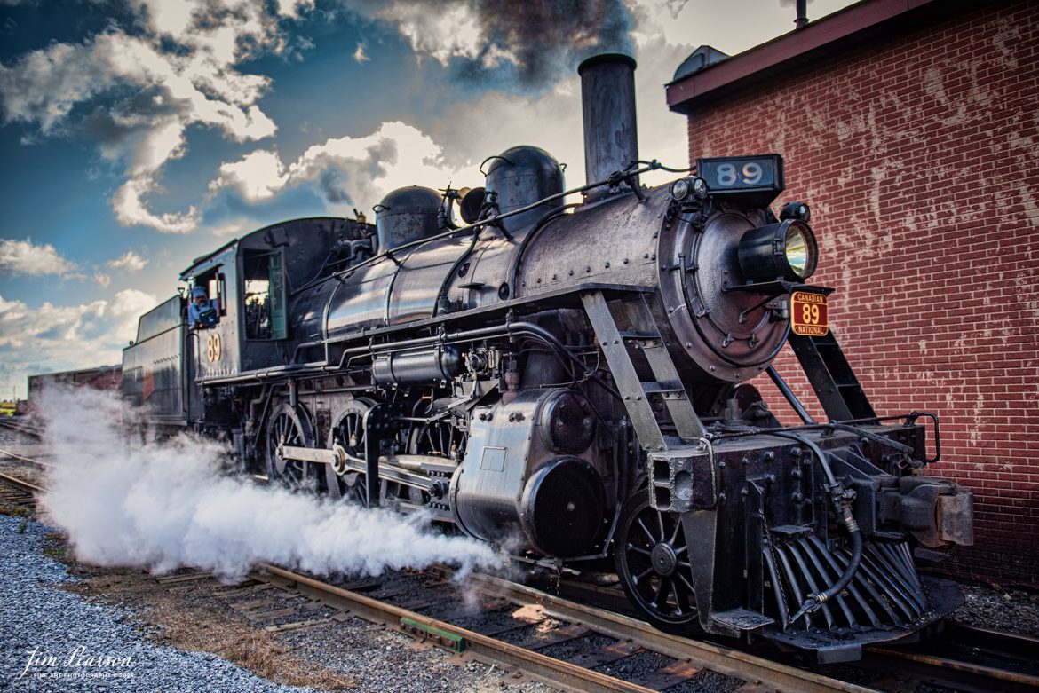 Canadian National 89 pulls past the engine house at the Strasburg Railroad as It prepares to pull the first train of the day on October 7th, 2024.

According to Wikipedia: The Strasburg Rail Road (reporting mark SRC) is a heritage railroad and the oldest continuously operating standard-gauge railroad in the western hemisphere, as well as the oldest public utility in the Commonwealth of Pennsylvania. Chartered in 1832, the Strasburg Rail Road Company is today a heritage railroad offering excursion trains hauled by steam locomotives on 4.02 mi of track in Pennsylvania Dutch Country, as well as providing contract railroad mechanical services, and freight service to area shippers. The railroad's headquarters are outside Strasburg, Pennsylvania.

Tech Info: Nikon D810, RAW, Nikon 24-70 @ 24mm, 2.8, 1/1600, ISO 250.

#railroad #railroads #train, #trains #railway #railway #steamtrains #railtransport #railroadengines #picturesoftrains #picturesofrailways #besttrainphotograph #bestphoto #photographyoftrains #bestsoldpicture #JimPearsonPhotography #StrasburgRailroad