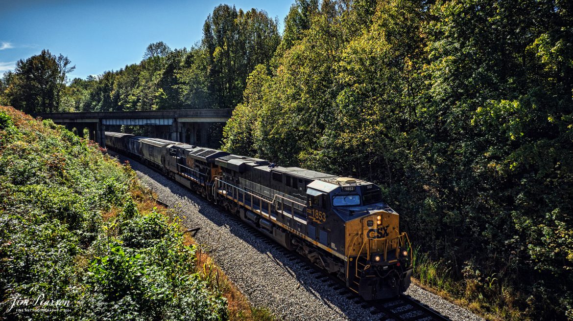 CSX M498, with the New York Central heritage 1877 unit leading, passes under the highway 41 overpass at Mortons Gap, Kentucky as it heads north on the CSX Henderson Subdivision, on October 19th, 2024. 

According to the CSX Website: January 3, 2024 - A CSX locomotive commemorating the New York Central Railroad has become the eighth unit in CSX’s heritage locomotive fleet.

Designated CSX 1853 in recognition of the year the NYC was founded, the newest heritage unit was repainted in a special design combining the current CSX colors with the traditional gray and white of the NYC system. The NYC heritage unit has been placed into regular revenue service, proudly carrying the NYC colors across the CSX network.

All of the heritage unit paint schemes have been created at the CSX Waycross Locomotive Shop, where employees performed the challenging work of applying the unique designs. Click below to watch a video of CSX 1853 rolling out of the Waycross shop and hear employees describe the 22-day effort to repaint the unit. 

At its height, the New York Central system encompassed more than 11,000 track miles and provided vital transportation service between New England and the Midwest. It merged with the Pennsylvania Railroad to become the Penn Central in 1968 and later became part of Conrail.

A majority of former NYC lines were acquired by CSX in 1998, and today CSX employees continue to operate trains across the primary NYC routes that have been carrying freight and supporting the U.S. economy for more than a century.

Tech Info: DJI Mavic 3 Classic Drone, RAW, 24mm, f/2.8, 1/2000, ISO 190.

#picturesofrailways #besttrainphotograph #bestphoto #photographyoftrains #bestsoldpicture #JimPearsonPhotography