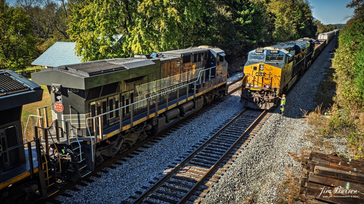 CSX 498 with the New York Central heritage 1877 unit leading meets CSX M513 at the south end of the siding at Slaughters, Kentucky as it heads north on the CSX Henderson Subdivision, on October 19th, 2024. 

According to the CSX Website: January 3, 2024 - A CSX locomotive commemorating the New York Central Railroad has become the eighth unit in CSX’s heritage locomotive fleet.

Designated CSX 1853 in recognition of the year the NYC was founded, the newest heritage unit was repainted in a special design combining the current CSX colors with the traditional gray and white of the NYC system. The NYC heritage unit has been placed into regular revenue service, proudly carrying the NYC colors across the CSX network.

All of the heritage unit paint schemes have been created at the CSX Waycross Locomotive Shop, where employees performed the challenging work of applying the unique designs. Click below to watch a video of CSX 1853 rolling out of the Waycross shop and hear employees describe the 22-day effort to repaint the unit. 

At its height, the New York Central system encompassed more than 11,000 track miles and provided vital transportation service between New England and the Midwest. It merged with the Pennsylvania Railroad to become the Penn Central in 1968 and later became part of Conrail.

A majority of former NYC lines were acquired by CSX in 1998, and today CSX employees continue to operate trains across the primary NYC routes that have been carrying freight and supporting the U.S. economy for more than a century.

Tech Info: DJI Mavic 3 Classic Drone, RAW, 24mm, f/2.8, 1/1600, ISO 110.

#picturesofrailways #besttrainphotograph #bestphoto #photographyoftrains #bestsoldpicture #JimPearsonPhotography