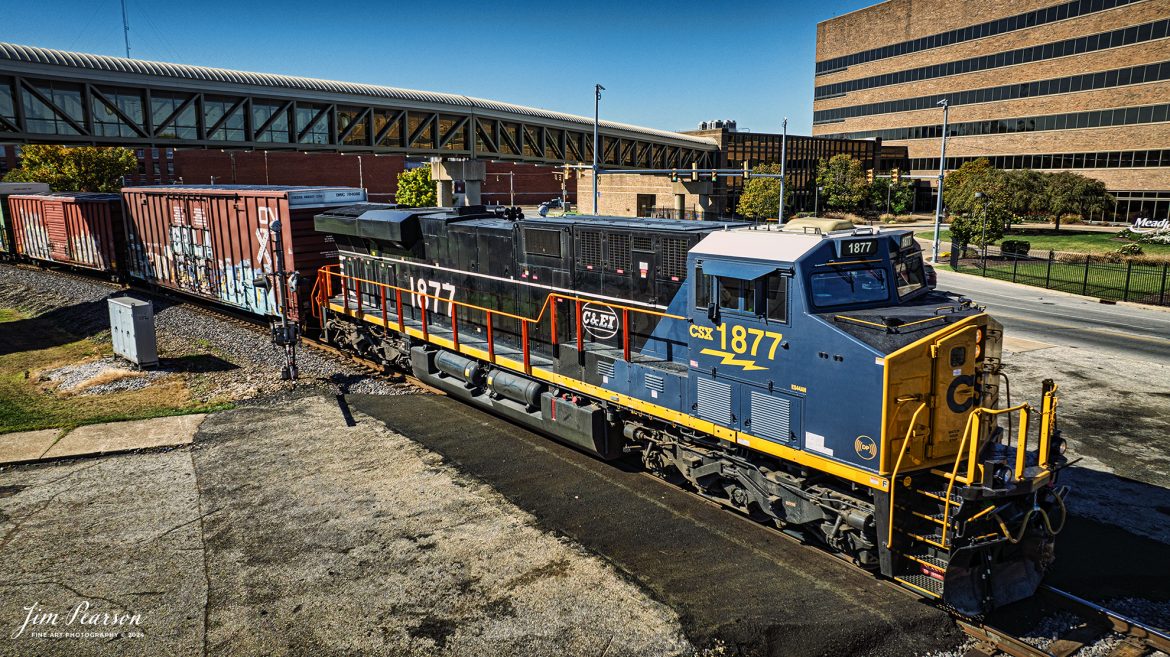 CSX M648 with the Chicago and Eastern Illinois Railroad (CE&I) heritage unit leading heads north from Evansville, Indiana on the CSX Evansville Terminal Subdivision on October 26th, 2024. 

Here it's passing under the pedestrian overpass for Mead Johnson at Evansville and on the subdivision that the CE&I originally ran on, between Evansville, Indiana and Chicago, Illinois.

According to the CSX Website: July 26, 2024 - CSX has unveiled its 17th heritage locomotive, paying tribute to the historic Chicago and Eastern Illinois Railroad. This locomotive is part of CSX's ongoing series celebrating the rich legacy of America's railroads.

The C&EI was established in 1877, initially serving as a regional line connecting Chicago with southern Illinois, St. Louis, Mo. and Evansville, Ind. Over time, it expanded its reach, becoming an important link between the Midwest and the southern United States. The C&EI played a vital role in transporting coal, agricultural products, and manufactured goods, significantly contributing to the region's economic development.

In 1967, the C&EI was absorbed by the Missouri Pacific Railroad and the Louisville and Nashville Railroad. In the 1980s, as CSX expanded its network, it acquired various lines and assets from other railroads, including parts of former C&EI lines that had been integrated into the Missouri Pacific. This indirect acquisition process allowed CSX to incorporate the historic routes and legacy of the C&EI into its expansive system.

Tech Info: DJI Mavic 3 Classic Drone, RAW, 24mm, f/2.8, 1/1600, ISO 110.

#picturesofrailways #besttrainphotograph #bestphoto #photographyoftrains #bestsoldpicture #JimPearsonPhotography