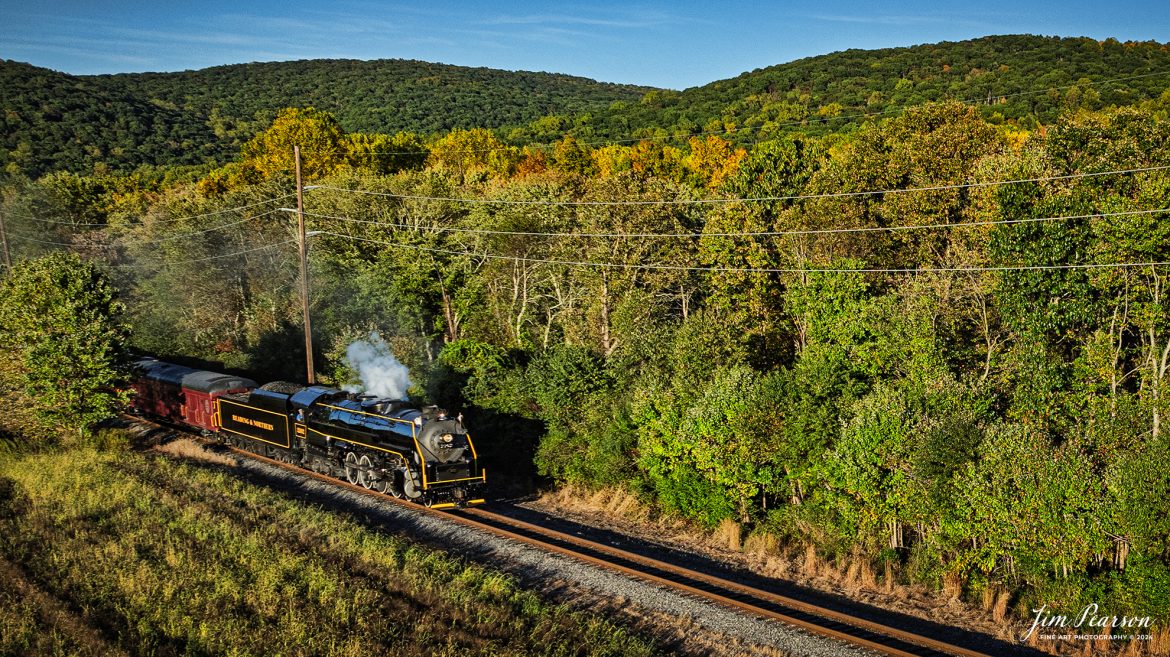 Reading Blue Northern Railroad steam locomotive 2102 leads a passenger train as it heads through the countryside at Molino, Pennsylvania, on October 5th, 2024 as they head for Jim Thorpe during one of their fall excursions.

According to their website: The Reading Company T-1 class #2102 was built in the Reading’s own locomotive shops in 1945. With drivers of 70” diameter, it weighs 404 tons, and its tender holds up to 26 tons of coal, and up to 19,000 gallons of water. After the Reading Steam era was over, the Reading Company used 2102 for the Reading Rambles on several different excursions. The 2102 has had many different owners since it was retired by the Reading Railroad. It is one of only four to survive. The other remaining locomotives are the 2100, 2101, and 2124.

The Blue Mountain and Reading Railroad purchased the 2102 in 1987, and it ran on the Temple to South Hamburg line into the early 1990’s. Once the Blue Mountain and Reading Railroad became the Reading Blue Mountain & Northern, the 2102 ran over Reading & Northern’s rails for a short time before it was removed from service in the early 1990’s. 

In 2022, steam locomotive 2102 reentered service on the Reading & Northern. The locomotive has been used actively to pull both passenger excursions and revenue freight trains.

Tech Info: DJI Mavic 3 Classic Drone, RAW, 24mm, f/2.8, 1/1000, ISO 140.

#railroad #railroads #train, #trains #railway #railway #steamtrains #railtransport #railroadengines #picturesoftrains #picturesofrailways #besttrainphotograph #bestphoto #photographyoftrains #bestsoldpicture #JimPearsonPhotography #trainsfromadrone #readingbluenorthernrailroad