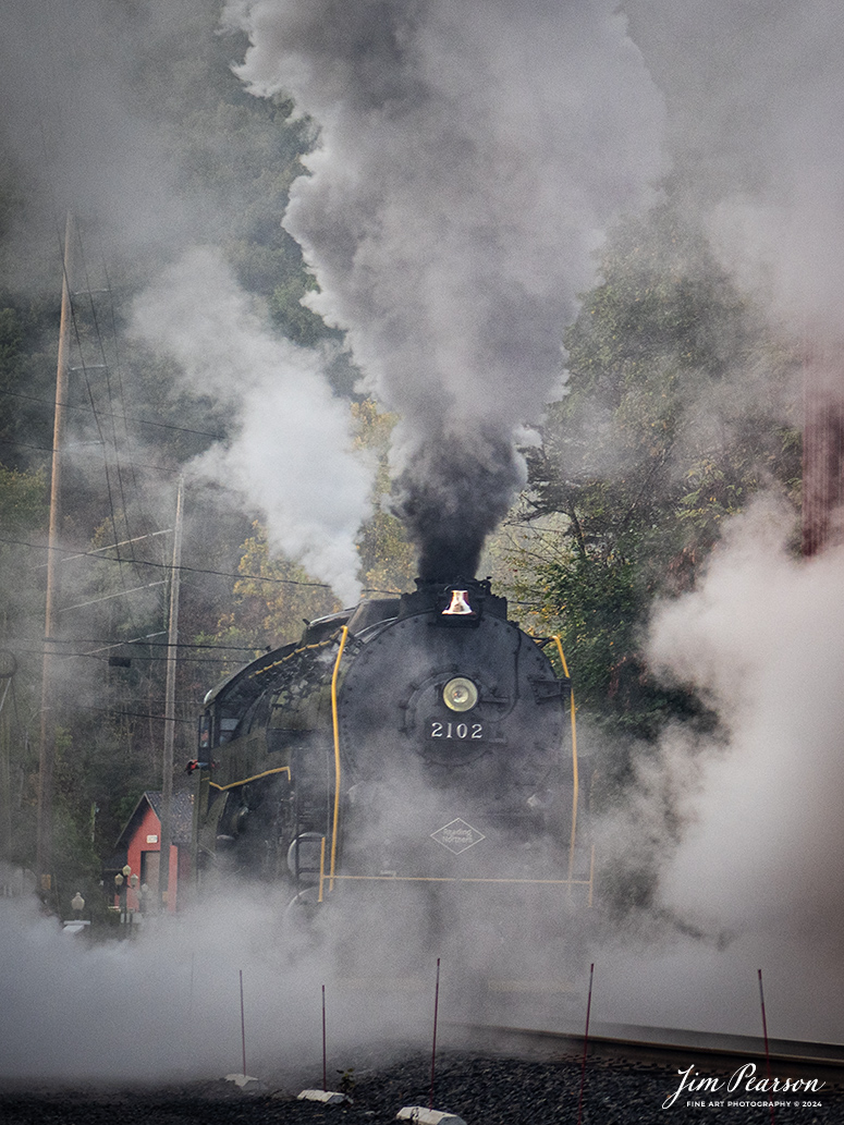 Reading Blue Mountain & Northern Railroad steam locomotive 2102 pulls past the engine house at Port Clinton, Pennsylvania on October 5th, 2024, as it heads to Reading, PA, to begin its first day of the year of pulling Fall Foliage Excursions.

According to their website: The Reading Company T-1 class #2102 was built in the Reading’s own locomotive shops in 1945. With drivers of 70” diameter, it weighs 404 tons, and its tender holds up to 26 tons of coal, and up to 19,000 gallons of water. After the Reading Steam era was over, the Reading Company used 2102 for the Reading Rambles on several different excursions. The 2102 has had many different owners since it was retired by the Reading Railroad. It is one of only four to survive. The other remaining locomotives are the 2100, 2101, and 2124.

The Blue Mountain and Reading Railroad purchased the 2102 in 1987, and it ran on the Temple to South Hamburg line into the early 1990’s. Once the Blue Mountain and Reading Railroad became the Reading Blue Mountain & Northern, the 2102 ran over Reading & Northern’s rails for a short time before it was removed from service in the early 1990’s. 

In 2022, steam locomotive 2102 reentered service on the Reading & Northern. The locomotive has been used actively to pull both passenger excursions and revenue freight trains.

Tech Info: Nikon D810, RAW, Nikon 24-70 @ 62mm, f/2.8, 1/160, ISO 250.

#railroad #railroads #train, #trains #railway #railway #steamtrains #railtransport #railroadengines #picturesoftrains #picturesofrailways #besttrainphotograph #bestphoto #photographyoftrains #bestsoldpicture #JimPearsonPhotography #RBNRR