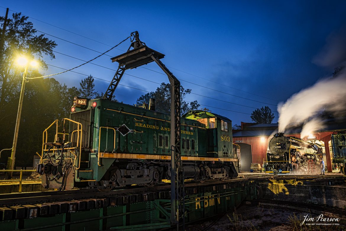 Reading Blue Mountain & Northern Railroad steam locomotive 2102 sits outside the engine house as Reading and Northern SW8M 803 waits on the turntable to pull it onto the main at Port Clinton, Pennsylvania on October 5th, 2024, for the first day of the year of 2102 pulling Fall Foliage Excursions.

From what I find on the web: Reading and Northern locomotive 803 is an EMD SW-8m model. ​ It was built in September 1951 with builder number 14495. It was previously owned by Conrail (CR) as 8684 and originally by Lehigh Valley (LV) as 270.

According to their website: The Reading Company T-1 class #2102 was built in the Reading’s own locomotive shops in 1945. With drivers of 70” diameter, it weighs 404 tons, and its tender holds up to 26 tons of coal, and up to 19,000 gallons of water. After the Reading Steam era was over, the Reading Company used 2102 for the Reading Rambles on several different excursions. The 2102 has had many different owners since it was retired by the Reading Railroad. It is one of only four to survive. The other remaining locomotives are the 2100, 2101, and 2124.

The Blue Mountain and Reading Railroad purchased the 2102 in 1987, and it ran on the Temple to South Hamburg line into the early 1990’s. Once the Blue Mountain and Reading Railroad became the Reading Blue Mountain & Northern, the 2102 ran over Reading & Northern’s rails for a short time before it was removed from service in the early 1990’s. 

In 2022, steam locomotive 2102 reentered service on the Reading & Northern. The locomotive has been used actively to pull both passenger excursions and revenue freight trains.

Tech Info: Nikon D810, RAW, Nikon 24-70 @ 24mm, 2.5 seconds, f/5.6, ISO 200.

#railroad #railroads #train, #trains #railway #railway #steamtrains #railtransport #railroadengines #picturesoftrains #picturesofrailways #besttrainphotograph #bestphoto #photographyoftrains #bestsoldpicture #JimPearsonPhotography #RBNRR