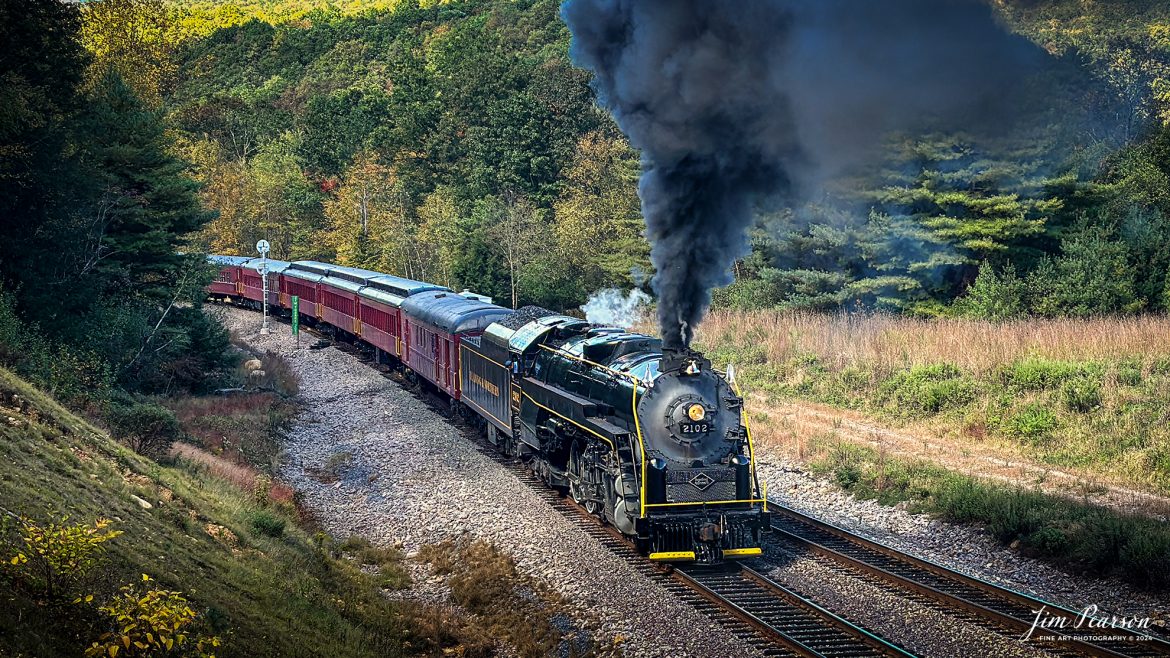 Reading Blue Mountain & Northern Railroad steam locomotive 2102 backs into the wye just outside Jim Thorp, Pennsylvania on October 5th, 2024, as it turns the train for their return trip to Port Clinton, PA during their first day of the year of pulling Fall Foliage Excursions.

According to their website: The Reading Company T-1 class #2102 was built in the Reading’s own locomotive shops in 1945. With drivers of 70” diameter, it weighs 404 tons, and its tender holds up to 26 tons of coal, and up to 19,000 gallons of water. After the Reading Steam era was over, the Reading Company used 2102 for the Reading Rambles on several different excursions. The 2102 has had many different owners since it was retired by the Reading Railroad. It is one of only four to survive. The other remaining locomotives are the 2100, 2101, and 2124.

The Blue Mountain and Reading Railroad purchased the 2102 in 1987, and it ran on the Temple to South Hamburg line into the early 1990’s. Once the Blue Mountain and Reading Railroad became the Reading Blue Mountain & Northern, the 2102 ran over Reading & Northern’s rails for a short time before it was removed from service in the early 1990’s. 

In 2022, steam locomotive 2102 reentered service on the Reading & Northern. The locomotive has been used actively to pull both passenger excursions and revenue freight trains.

Tech Info: iPhone 14 Pro, normal lens, f/1.8, 1/921th, ISO 80.

#railroad #railroads #train, #trains #railway #railway #steamtrains #railtransport #railroadengines #picturesoftrains #picturesofrailways #besttrainphotograph #bestphoto #photographyoftrains #bestsoldpicture #JimPearsonPhotography #RBNRR #iPhone