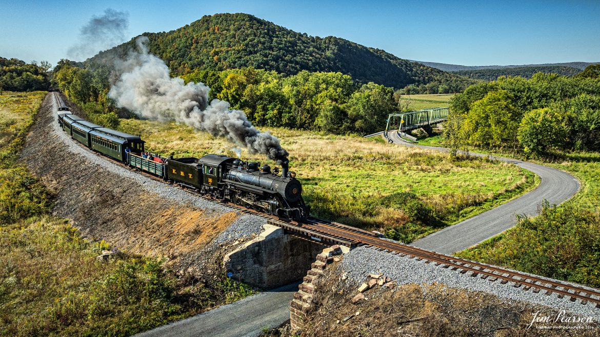 East Broad Top (EBT) steam locomotive #16 pulls a passenger train out of Rockhill Furnace, Pennsylvania on October 6th, 2024, on a beautiful fall morning.

According to the East Broad Top Website: Locomotive #16 was built in 1916 by the Baldwin Locomotive Works.

Entering the age of modern steam in 1916, the EBT received its first of three large Mikados. Unlike the previous three smaller locomotives, #16 came with superheaters, piston valves, and Southern valve gear. One story mentions #16 pulled 60 empty hoppers from Mt. Union to Rockhill in one train, literally clearing out the yard. #16 underwent an overhaul in 1955 and made only a handful of trips in early 1956 before the railroad shut down an overhaul when the EBT shut down. On February 1, 2023, the locomotive returned to service.

Tech Info: DJI Mavic 3 Classic Drone, RAW, 24mm, f/2.8, 1/1600, ISO 120.

#steamtrains #JimPearsonPhotography #trainsfromtheair #EastBroadTop