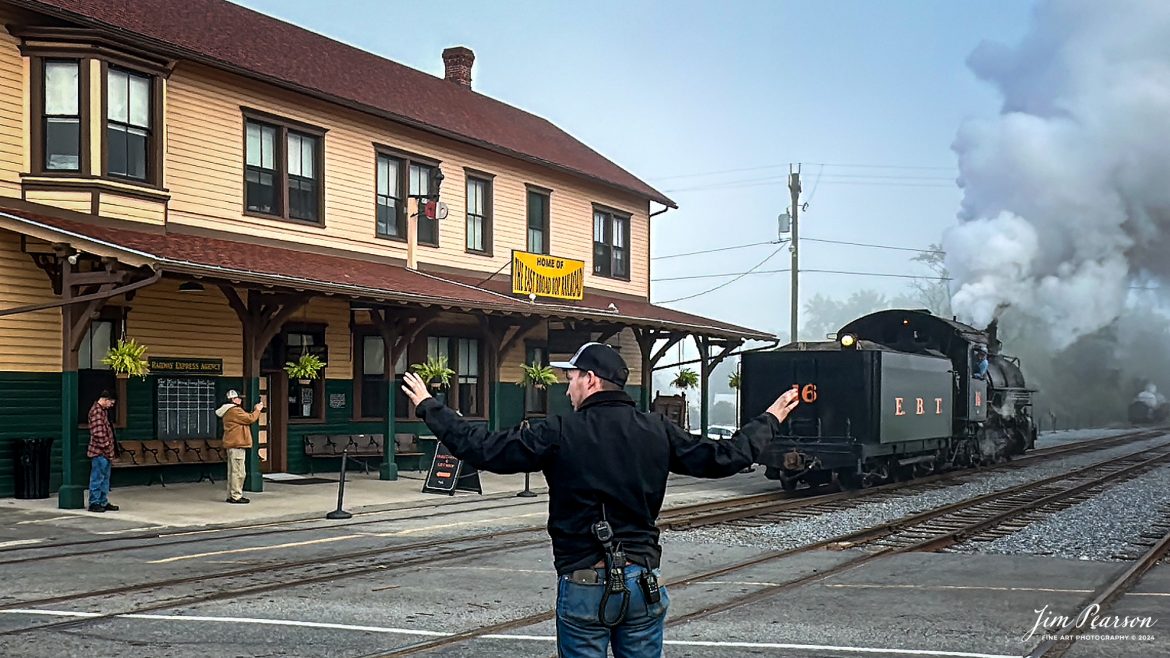 East Broad Top Railroad’s (EBT) Director of Sales and Marketing, Jonathan Smith, guards the crossing at the depot as EBT steam engine #16 backs up to their train in the yard at Rockhill Furnace, PA, on October 6h, 2024.

Tech Info: iPhone 14 Pro, normal lens, f/1.8, 1/727th, ISO 800.

#photographyoftrains #trainphotography #JimPearsonPhotography #trendingphoto #eastbroadtoprailroad #steamtrains