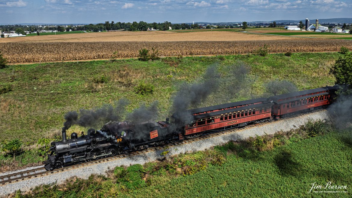 Canadian National 89 pulls a passenger train through the countryside on the Strasburg Railroad as It heads back to the depot at Strasburg, PA, on October 7th, 2024.

According to Wikipedia: The Strasburg Rail Road (reporting mark SRC) is a heritage railroad and the oldest continuously operating standard-gauge railroad in the western hemisphere, as well as the oldest public utility in the Commonwealth of Pennsylvania. Chartered in 1832, the Strasburg Rail Road Company is today a heritage railroad offering excursion trains hauled by steam locomotives on 4.02 mi of track in Pennsylvania Dutch Country, as well as providing contract railroad mechanical services, and freight service to area shippers. The railroad's headquarters are outside Strasburg, Pennsylvania.

Tech Info: DJI Mavic 3 Classic Drone, RAW, 24mm, f/2.8, 1/1600, ISO 100.

#photographyoftrains #bestsoldpicture #JimPearsonPhotography #StrasburgRailroad