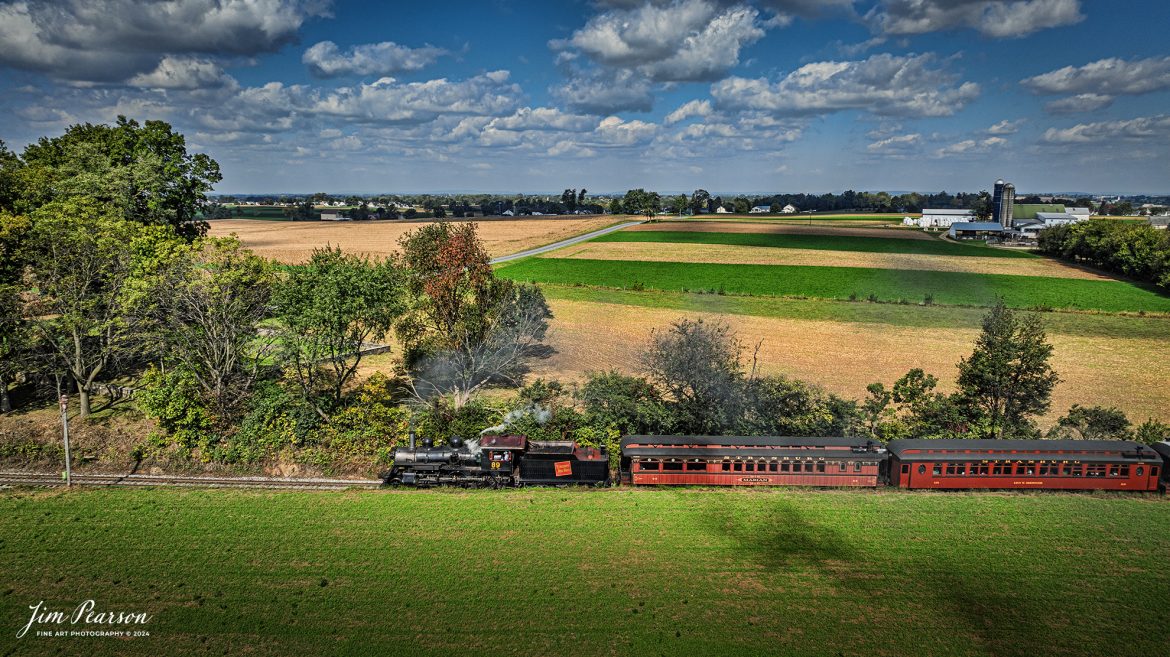 Canadian National 89 pulls a passenger train through the countryside on the Strasburg Railroad as It heads back to the depot at Strasburg, PA, on October 7th, 2024.

According to Wikipedia: The Strasburg Rail Road (reporting mark SRC) is a heritage railroad and the oldest continuously operating standard-gauge railroad in the western hemisphere, as well as the oldest public utility in the Commonwealth of Pennsylvania. Chartered in 1832, the Strasburg Rail Road Company is today a heritage railroad offering excursion trains hauled by steam locomotives on 4.02 mi of track in Pennsylvania Dutch Country, as well as providing contract railroad mechanical services, and freight service to area shippers. The railroad's headquarters are outside Strasburg, Pennsylvania.

Tech Info: DJI Mavic 3 Classic Drone, RAW, 24mm, f/2.8, 1/1600, ISO 100.

#photographyoftrains #bestsoldpicture #JimPearsonPhotography #StrasburgRailroad