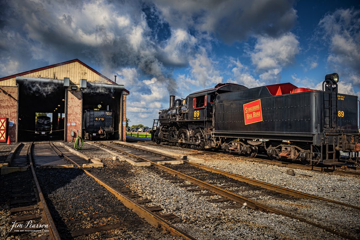 Canadian National 89 rests beside the engine house at the Strasburg Railroad as they wait to hook up to the first train of the day on October 7th, 2024, at Strasburg, Pennsylvania.

According to Wikipedia: The Strasburg Rail Road (reporting mark SRC) is a heritage railroad and the oldest continuously operating standard-gauge railroad in the western hemisphere, as well as the oldest public utility in the Commonwealth of Pennsylvania. Chartered in 1832, the Strasburg Rail Road Company is today a heritage railroad offering excursion trains hauled by steam locomotives on 4.02 mi of track in Pennsylvania Dutch Country, as well as providing contract railroad mechanical services, and freight service to area shippers. The railroad's headquarters are at Strasburg, Pennsylvania.

Tech Info: Nikon D810, RAW, Nikon 24-70 @ 24mm, 2.8, 1/1600, ISO 80.

#railroad #railroads #train, #trains #railway #railway #steamtrains #railtransport #railroadengines #picturesoftrains #picturesofrailways #besttrainphotograph #bestphoto #photographyoftrains #bestsoldpicture #JimPearsonPhotography #StrasburgRailroad