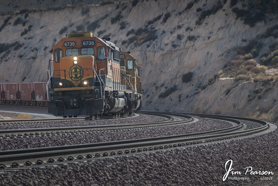 October 20, 2008 - A BNSF ballast train makes it's way west from the Summit of the Cajon Pass in Southern California with BNSF 6735 leading. 

Nikon D300, Nikon 70-300 @ 112mm, 1/500, f/6.3, ISO 200, RAW.