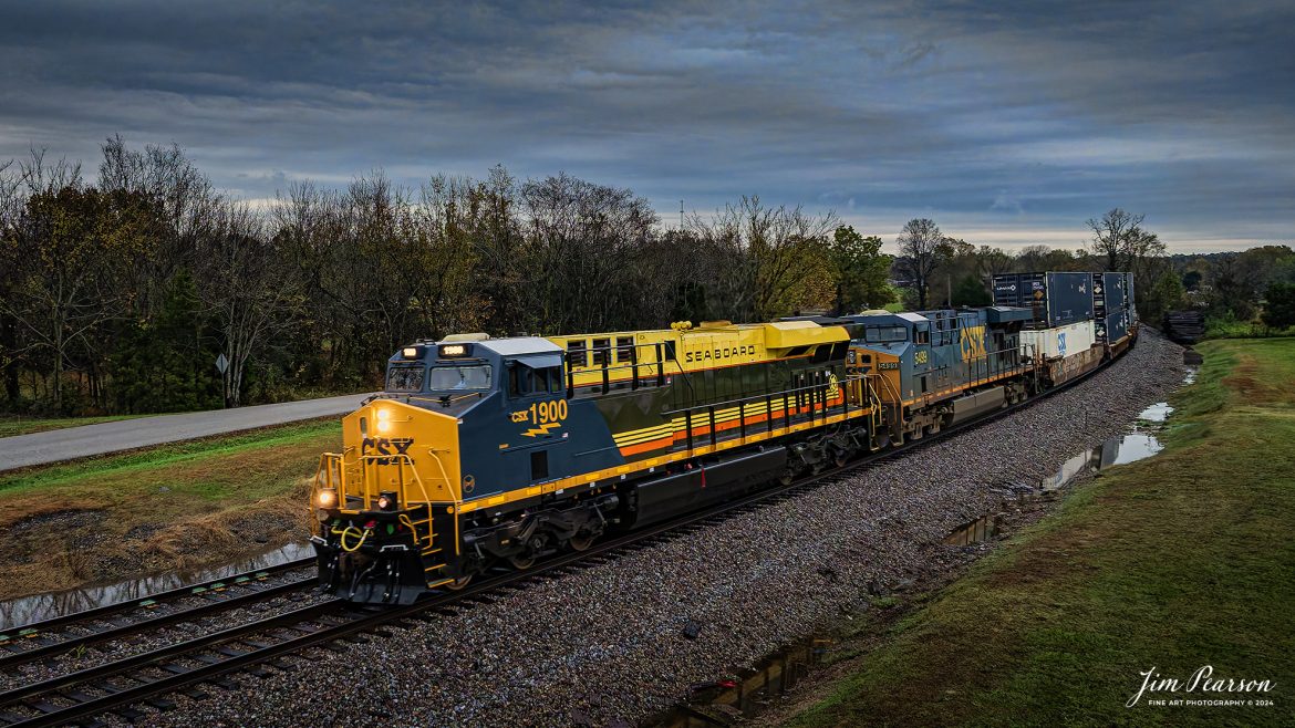 CSX I026 with CSX Seaboard Air Line Railroad Heritage Unit, 1900 leading, heads north at Kelly, Kentucky on the CSX Henderson Subdivision, on November 13th, 2024. 

According to a CSX Press Release: August 29, 2024 - CSX has unveiled its 18th heritage locomotive, a tribute to the Seaboard Air Line Railroad, marking another milestone in celebrating the rich history of American railroads. This latest addition to CSX's heritage series honors the legacy and the significant role that the Seaboard Air Line Railroad played in shaping the rail transport landscape in the United States.

The Seaboard Air Line Railroad, originally established in the late 19th century, was renowned for its efficient service and innovative routes, connecting the southeastern United States to the broader nation. Over the decades, it became famous for its passenger and freight services, symbolized by its slogan "Through the Heart of the South."

In 1967, Seaboard Air Line merged with the Atlantic Coast Line Railroad to form the Seaboard Coast Line Railroad. This merger was part of a larger trend in the railroad industry aimed at increasing efficiency and competitiveness. Eventually, Seaboard Coast Line became part of CSX Corporation in the 1980s through a series of mergers and consolidations that included the Chessie System and other lines. This ultimately positioned CSX as one of the leading rail networks in the U.S.

The creation of the Seaboard Air Line heritage unit was no small feat, showcasing the meticulous craftsmanship and dedication of ONE CSX team. Jeromy Hutchison, a CSX carman painter, commented on the complexity of the project, stating, "This was one of our harder projects. All of the stripes on the unit are hand laid, making it very complicated." The intricate detailing is a testament to the commitment delivering a great work product and honoring the legacy of the railroad. 

Tech Info: DJI Mavic 3 Classic Drone, RAW, 22mm, f/2.8, 1/320, ISO 800.

#besttrainphotograph #bestphoto #photographyoftrains #bestsoldpicture #JimPearsonPhotography #csxheritagelocomotive #onecsx